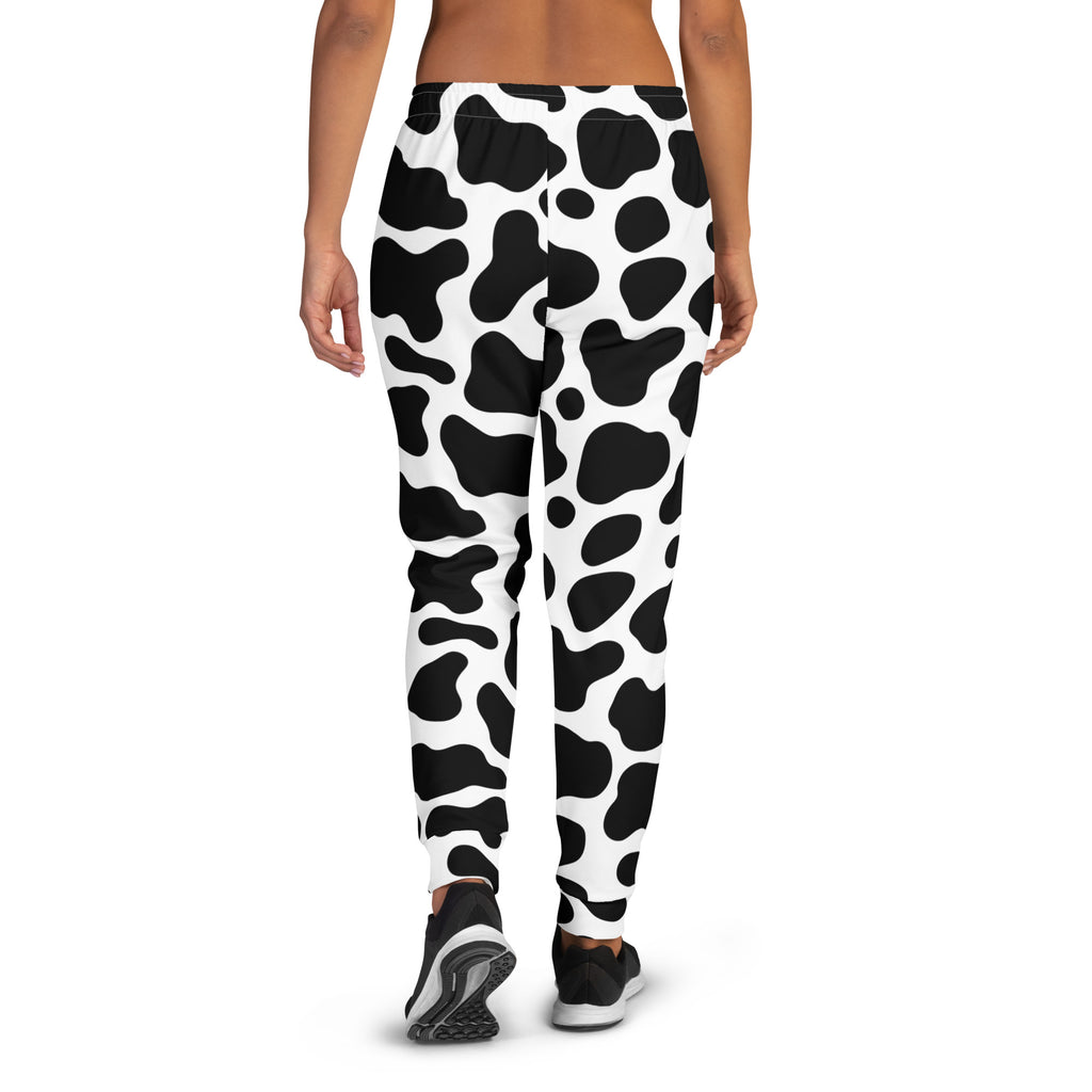 Women’s black and white cow print recycled jogger pants with pockets and cozy brushed inside fleece lining