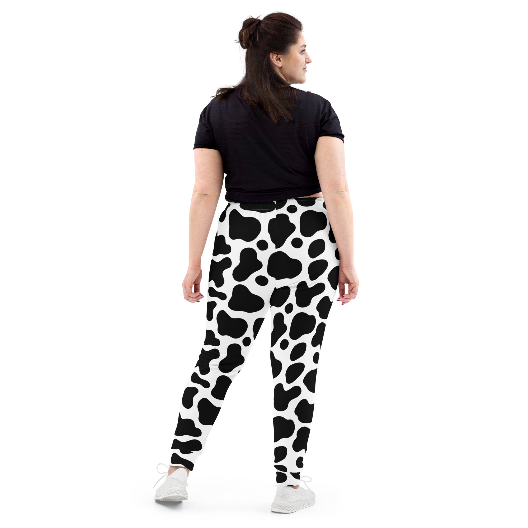 Women’s black and white cow print recycled jogger pants with pockets and cozy brushed inside fleece lining