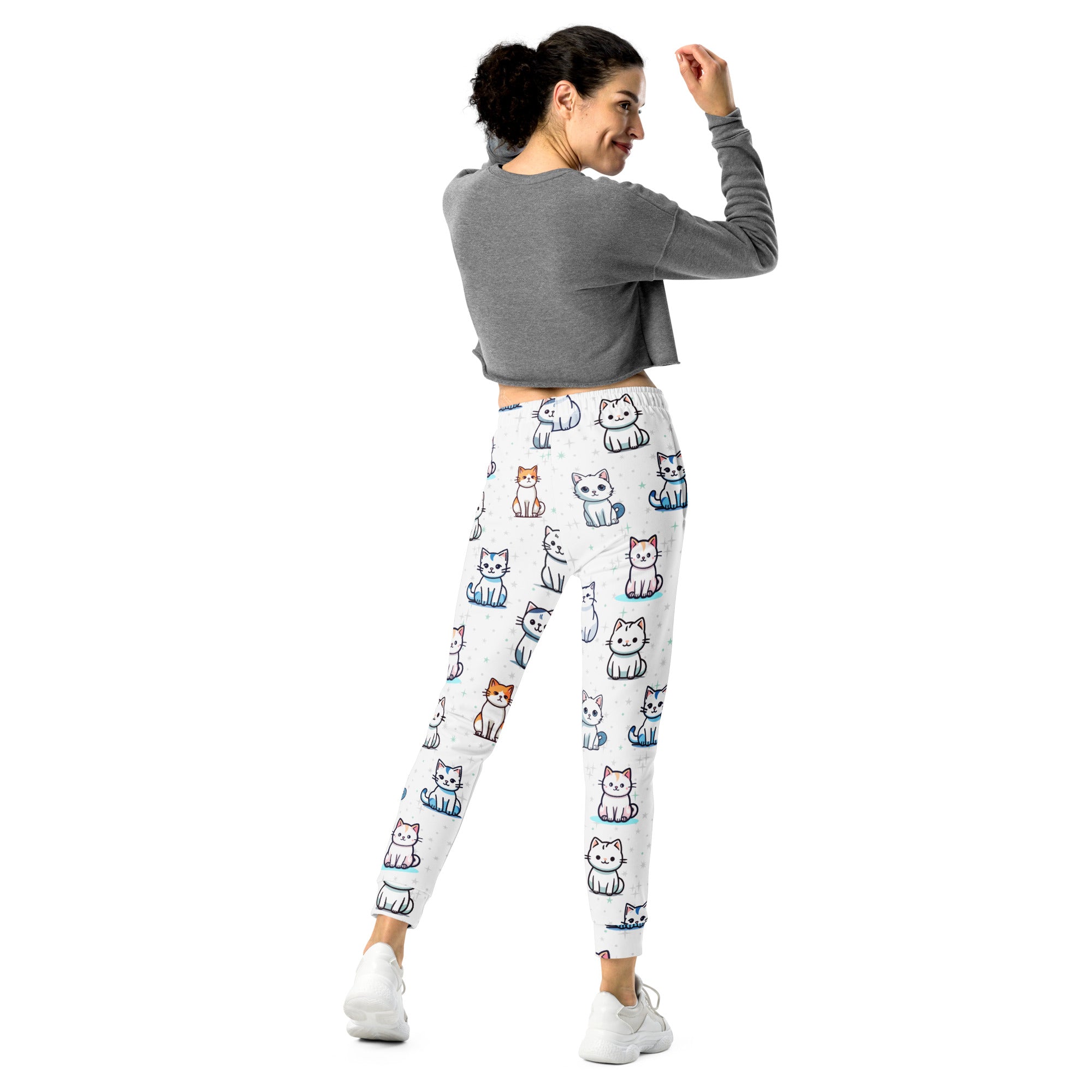 Women’s white recycled jogger pants with cozy fleece lining featuring colorful cartoon cat patterns and pockets