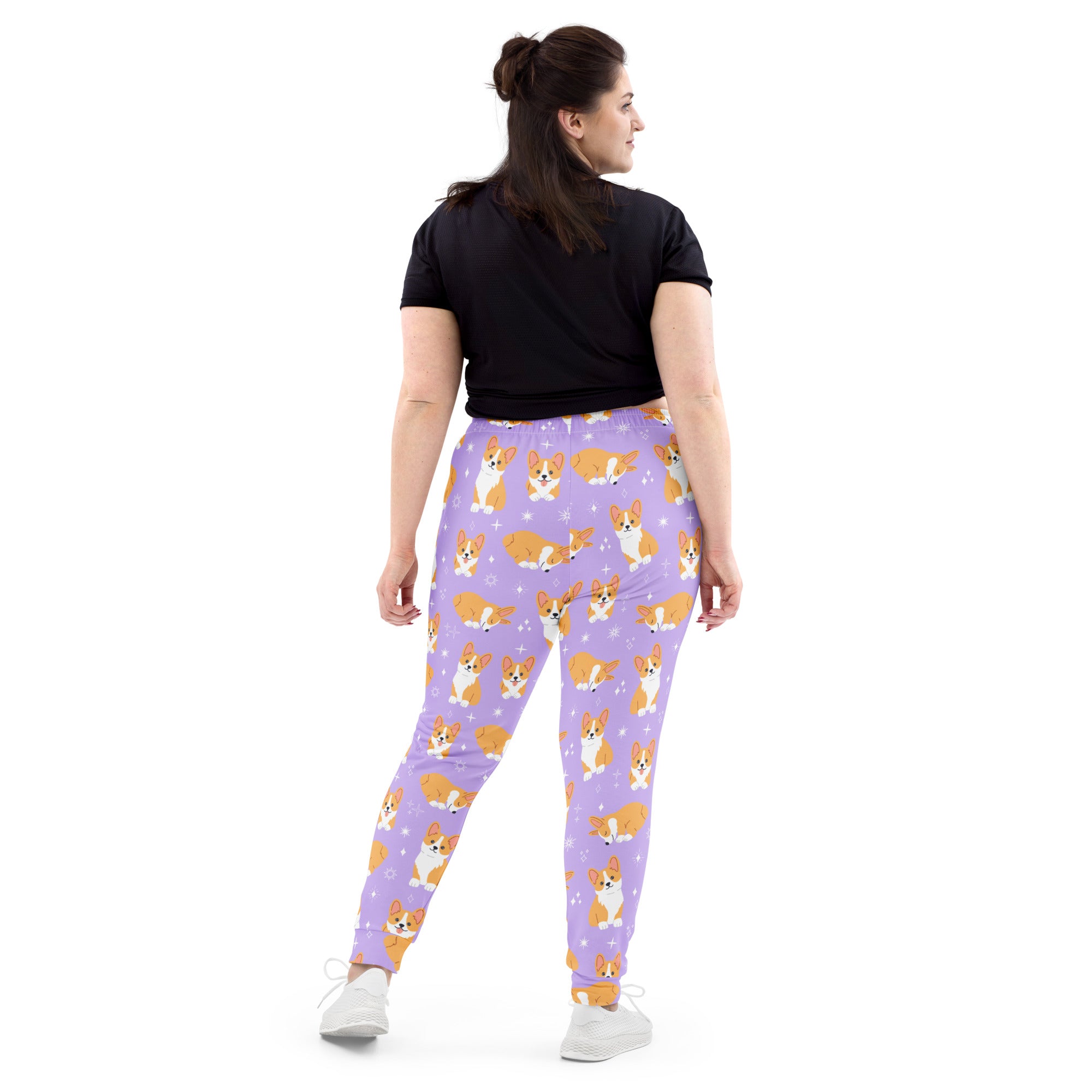 Women’s purple corgi dog recycled jogger pants with pockets feature a playful orange and white dog pattern on fleece
