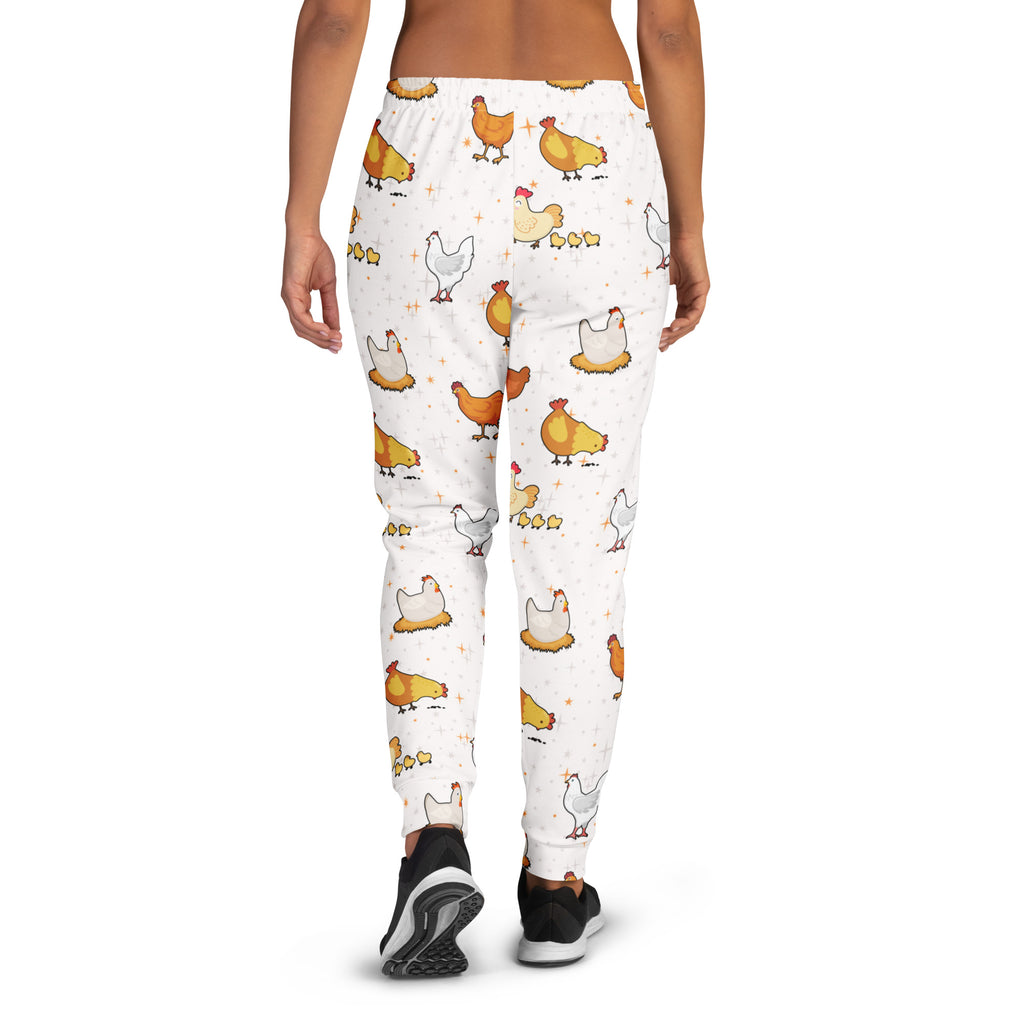 White women’s jogger pants with pockets featuring a playful orange yellow and white chicken pattern and cozy fleece lining