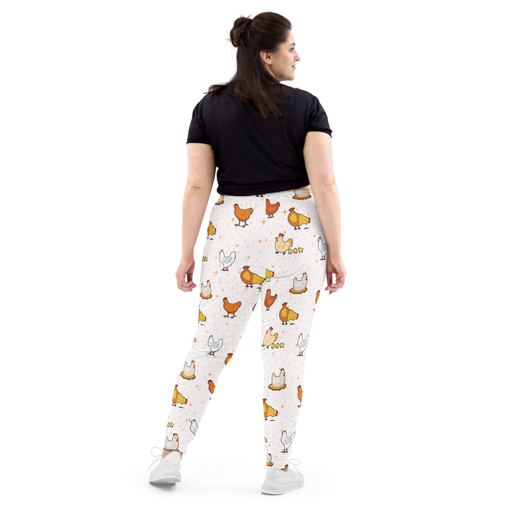 Women’s white recycled jogger pants with pockets featuring a playful orange yellow and white chicken pattern and cozy fleece lining