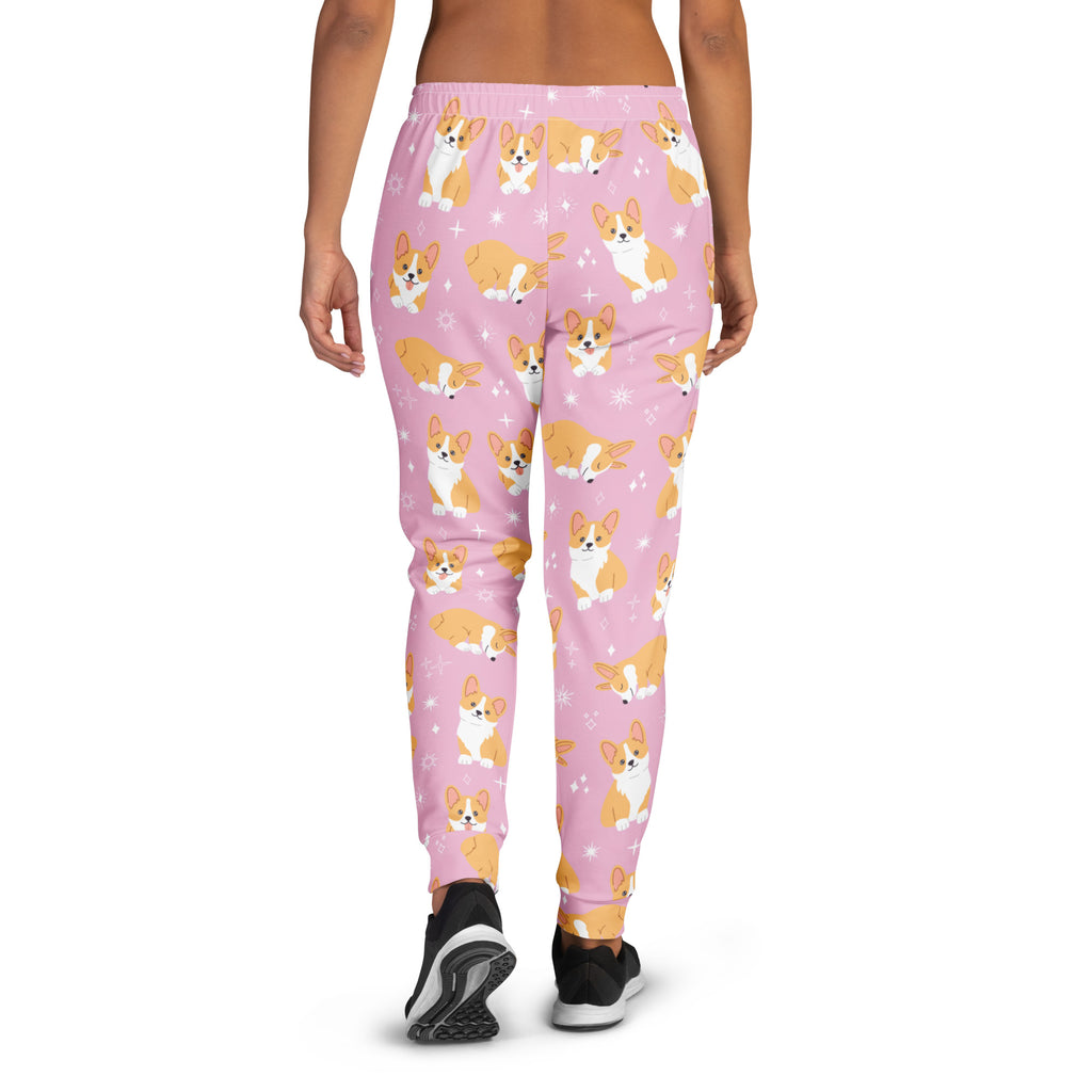 Women’s pink corgi dog recycled jogger pants with pockets featuring playful tan and white cartoon corgis and cozy fleece lining