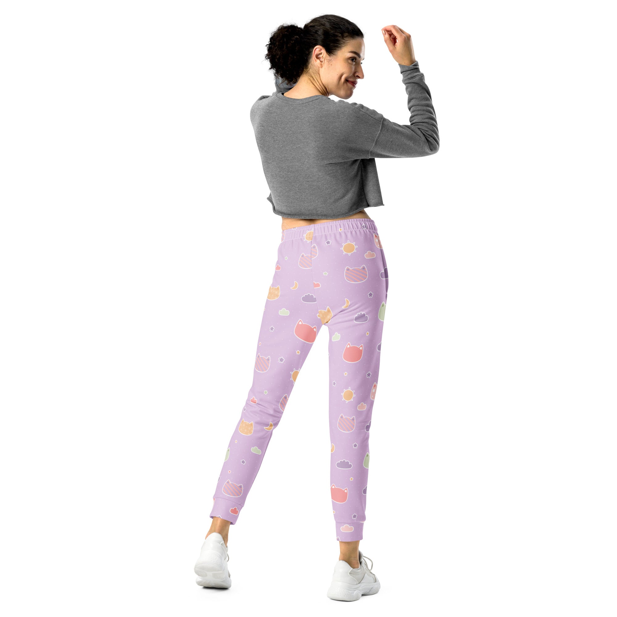 Women’s pastel purple jogger pants with playful kawaii cat faces and clouds made from cozy recycled fleece with pockets