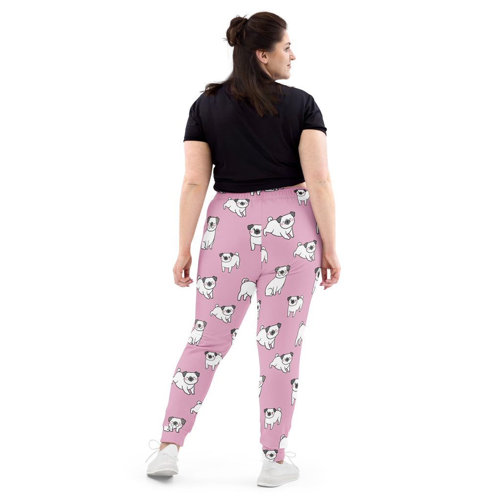 Women’s pink recycled jogger pants with pockets featuring playful white and black cartoon pug pattern and cozy fleece lining