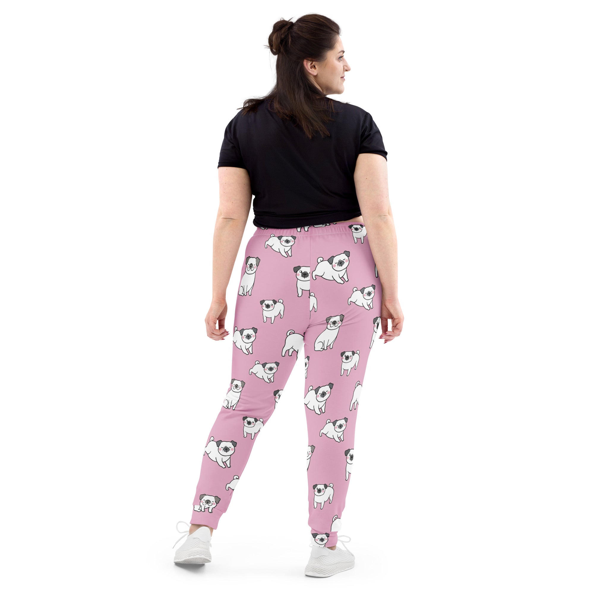 Women’s pink recycled jogger pants with pockets featuring playful white and black cartoon pug pattern and cozy fleece lining