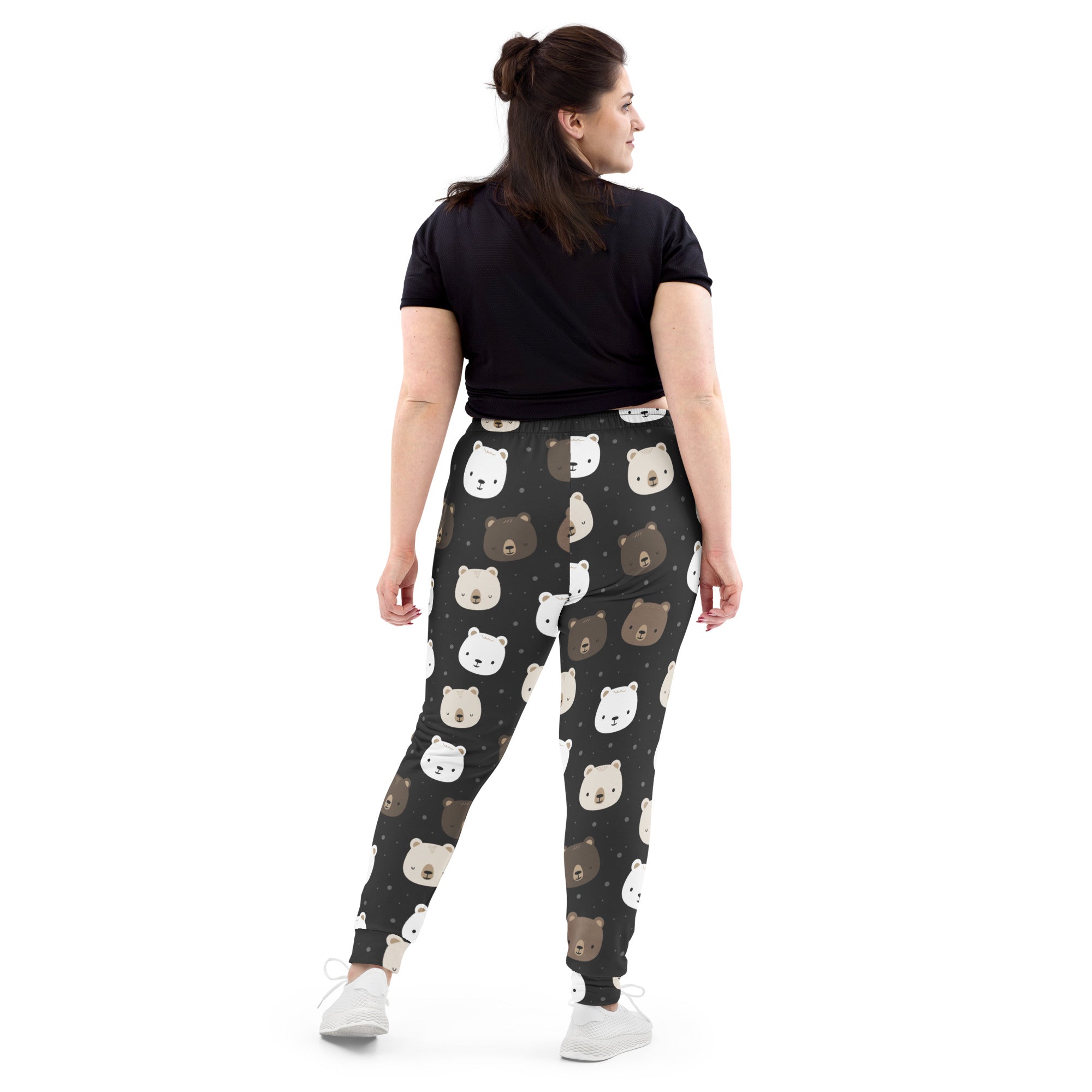 Women’s black recycled jogger pants with cozy brushed fleece inside and playful white and brown bear face pattern