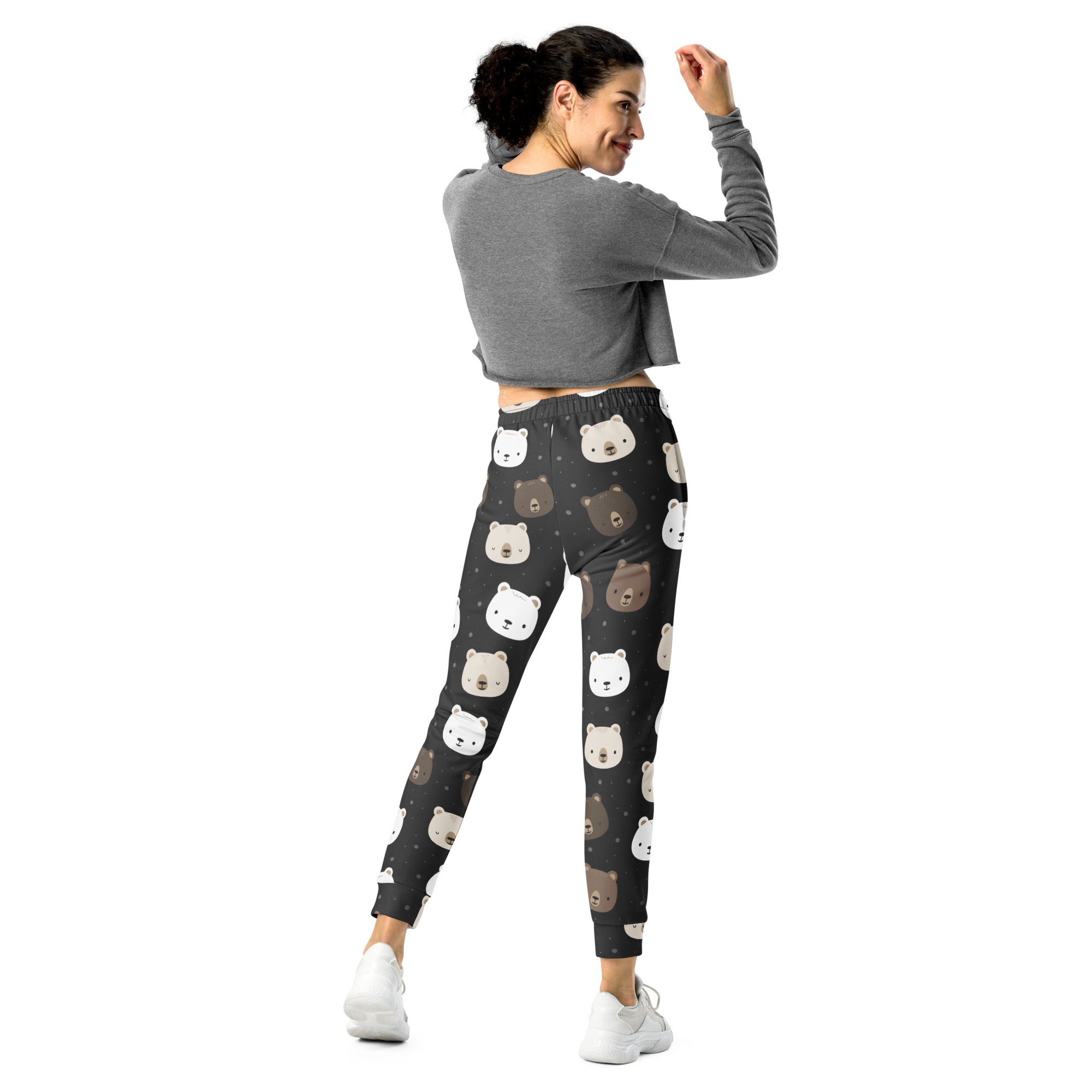 Women’s black recycled jogger pants with cozy fleece lining and playful white and brown bear face pattern with pockets