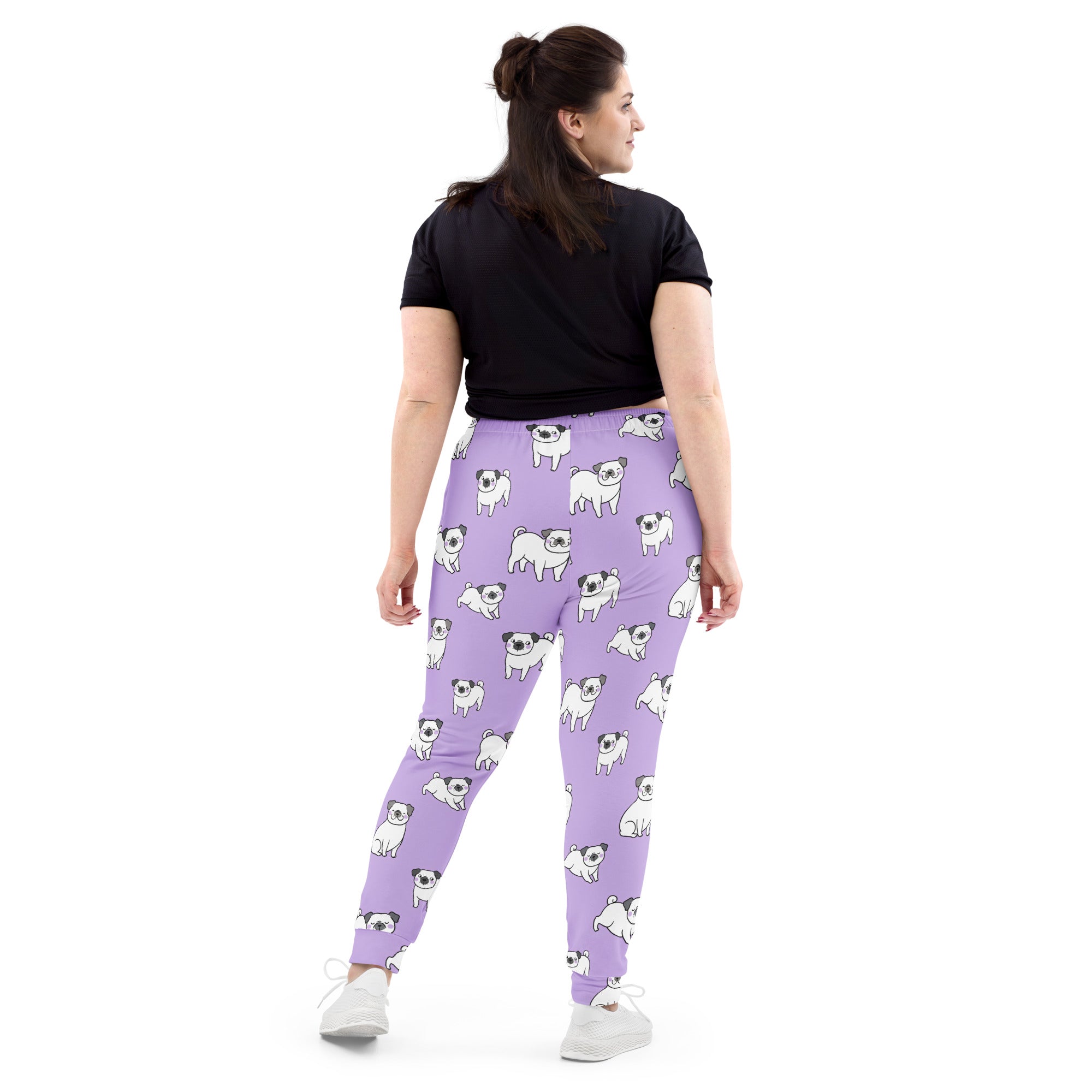 Women’s purple recycled jogger pants with pockets featuring white and black cartoon pug pattern and cozy brushed fleece lining