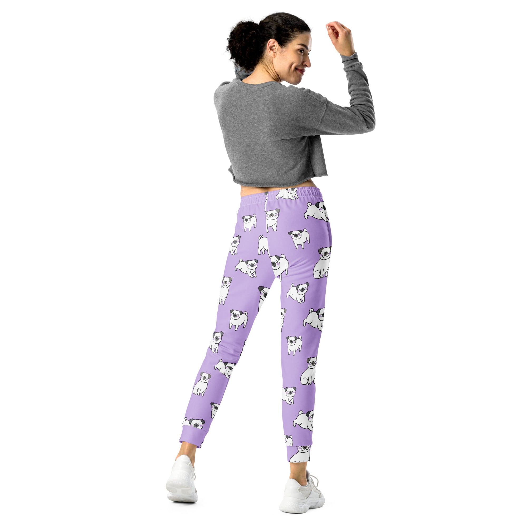 Women’s purple recycled jogger pants with cozy brushed fleece inside and a playful white cartoon pug pattern