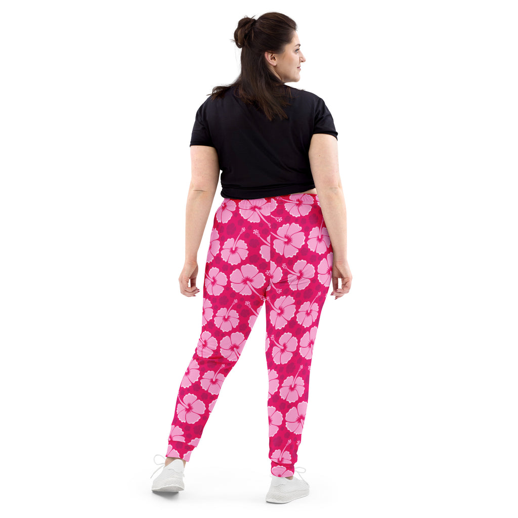 Women’s bright pink hibiscus floral jogger pants with cozy brushed inside fleece and pockets shown from front view