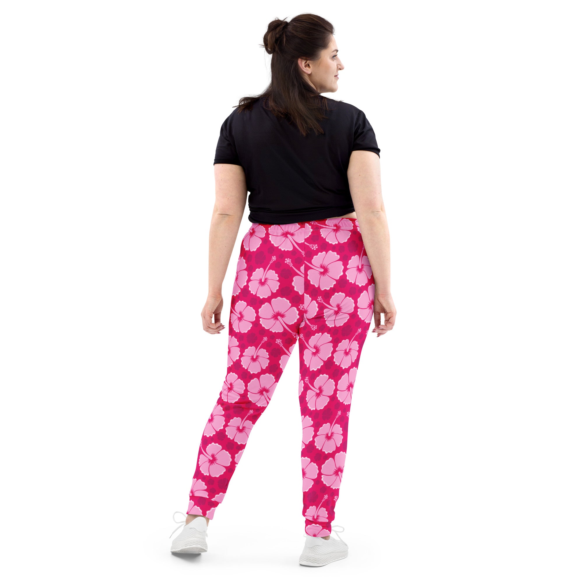 Women’s bright pink hibiscus floral jogger pants with cozy brushed inside fleece and pockets shown from front view