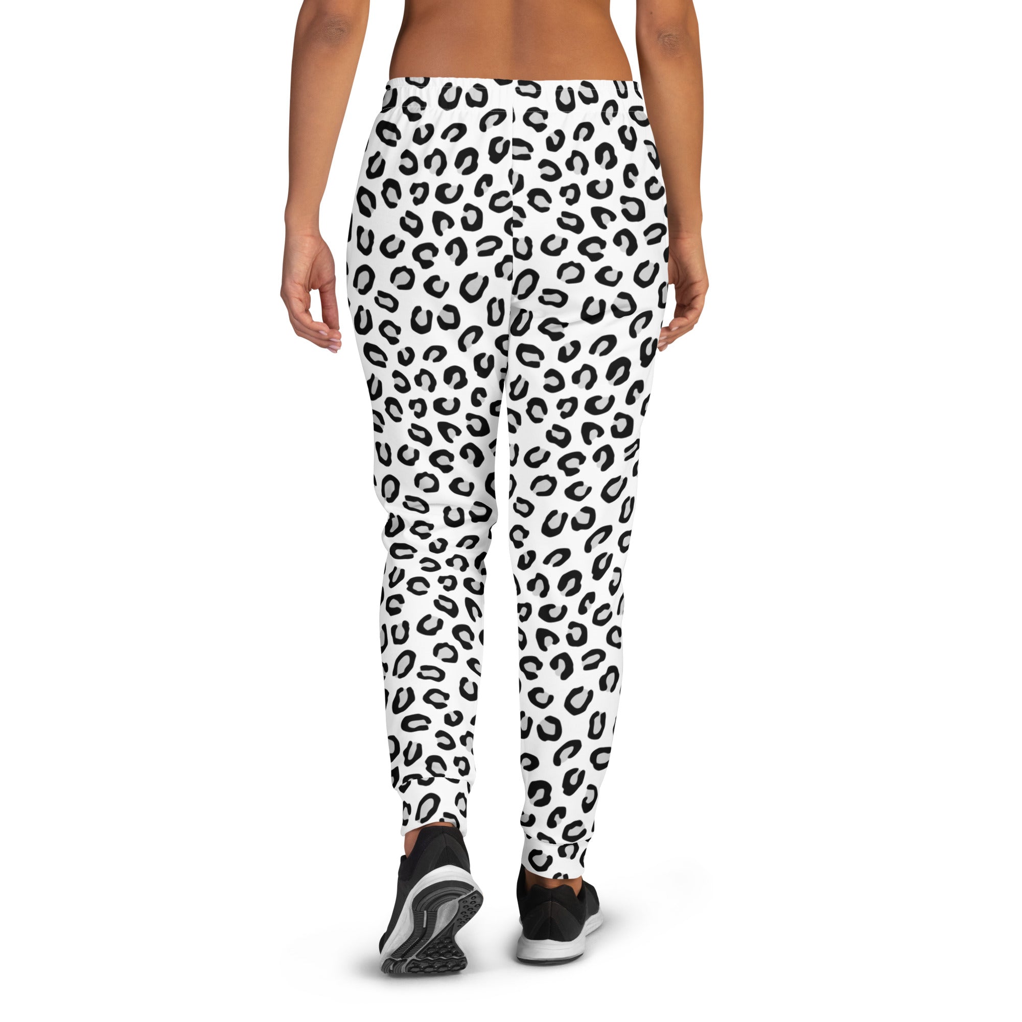 Women’s white leggings with bold black leopard print made from recycled fabric with cozy brushed fleece inside