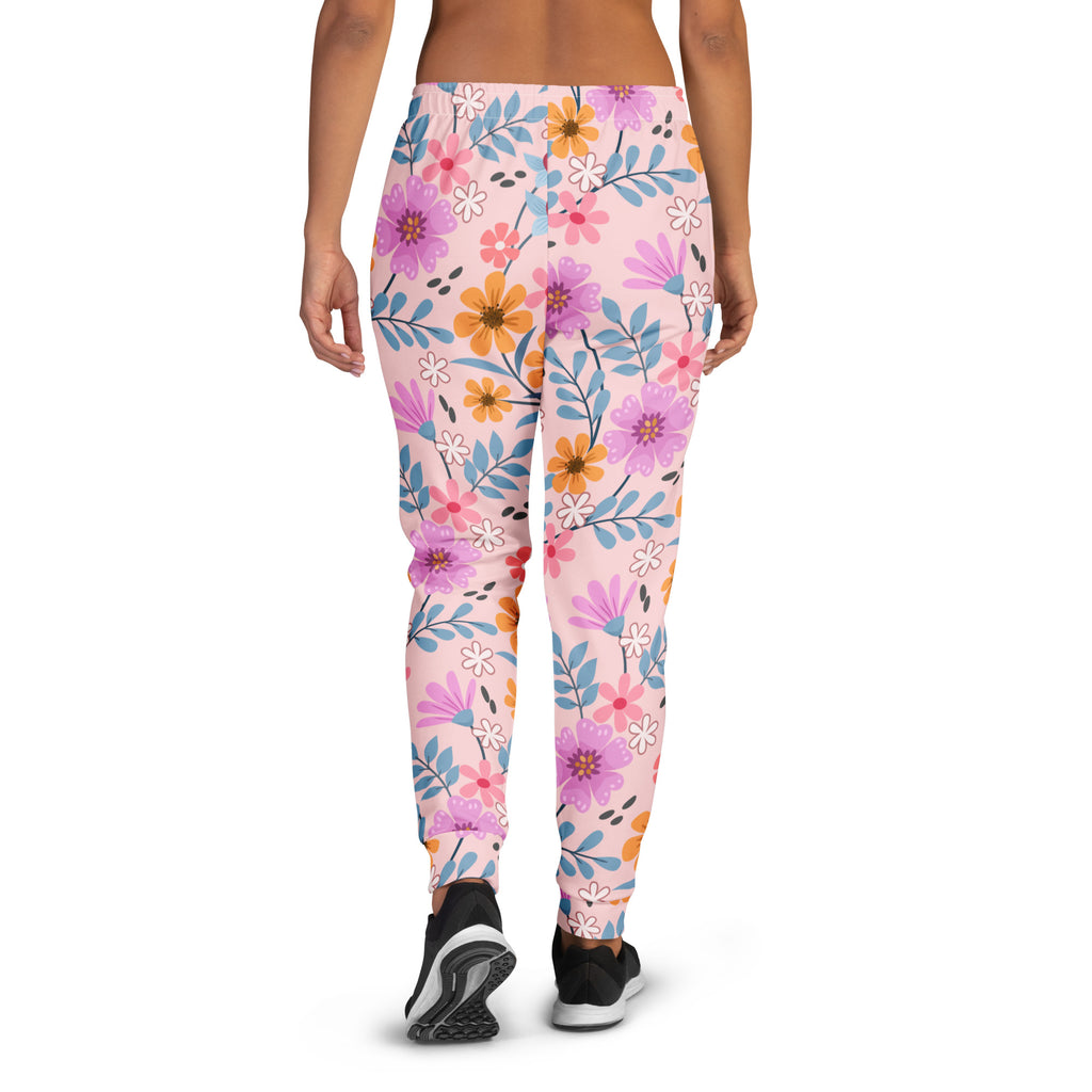 Women’s pink floral jogger pants with vibrant purple orange and blue flowers on soft recycled fleece with pockets