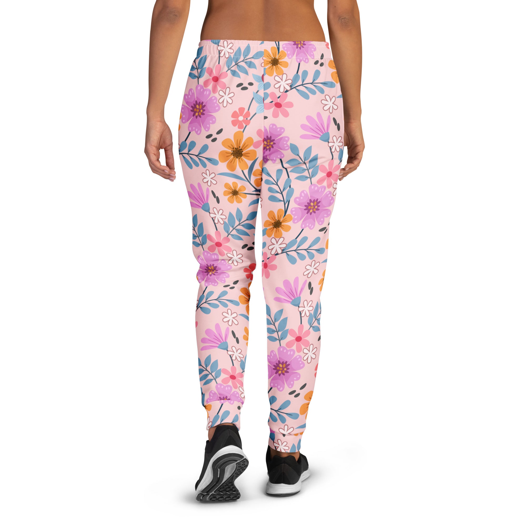 Women’s pink floral jogger pants with vibrant purple orange and blue flowers on soft recycled fleece with pockets