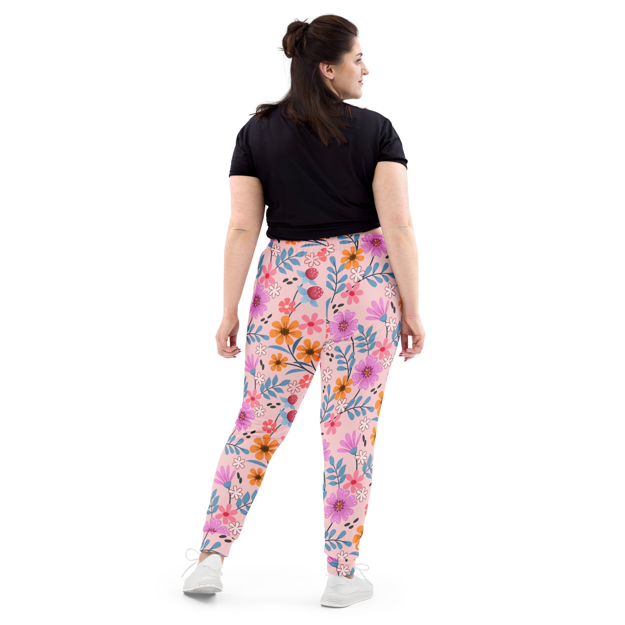 Women’s pink floral recycled jogger pants with pockets featuring vibrant orange, purple, and blue flowers on soft fleece
