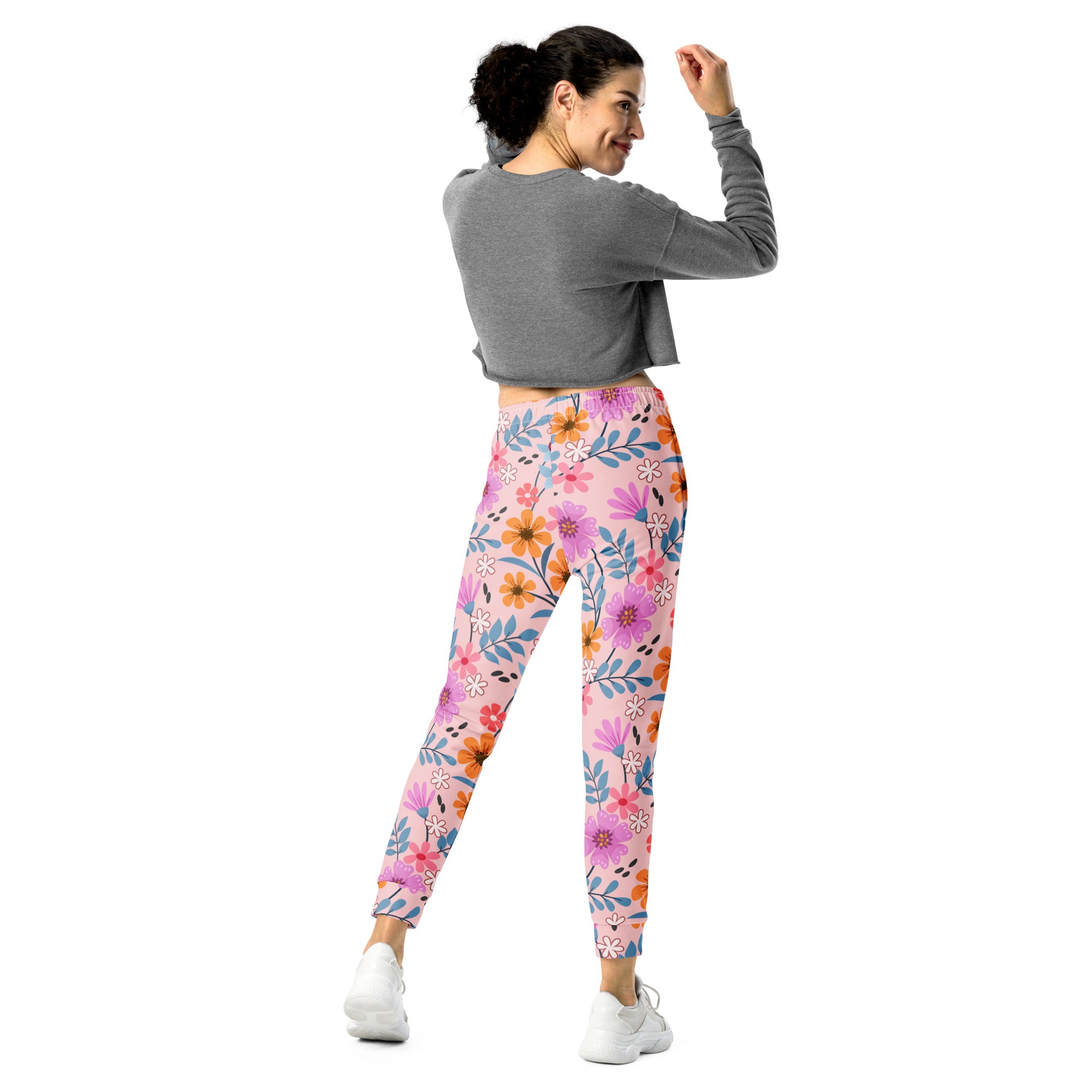 Women’s pink floral recycled jogger pants with pockets featuring purple orange and blue flowers on soft brushed fleece