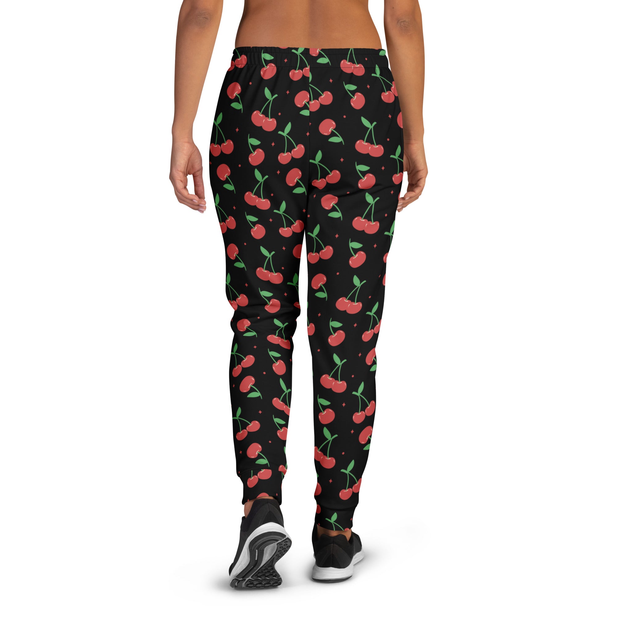 Women’s black cherry recycled jogger pants with cozy brushed fleece inside and red cherry pattern with pockets