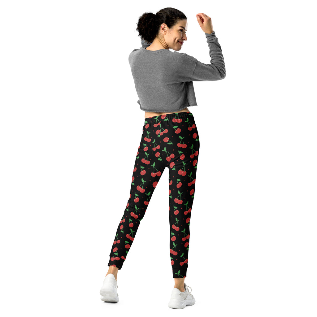 Women’s black cherry recycled jogger pants with vibrant red cherry pattern and cozy brushed inside fleece lining