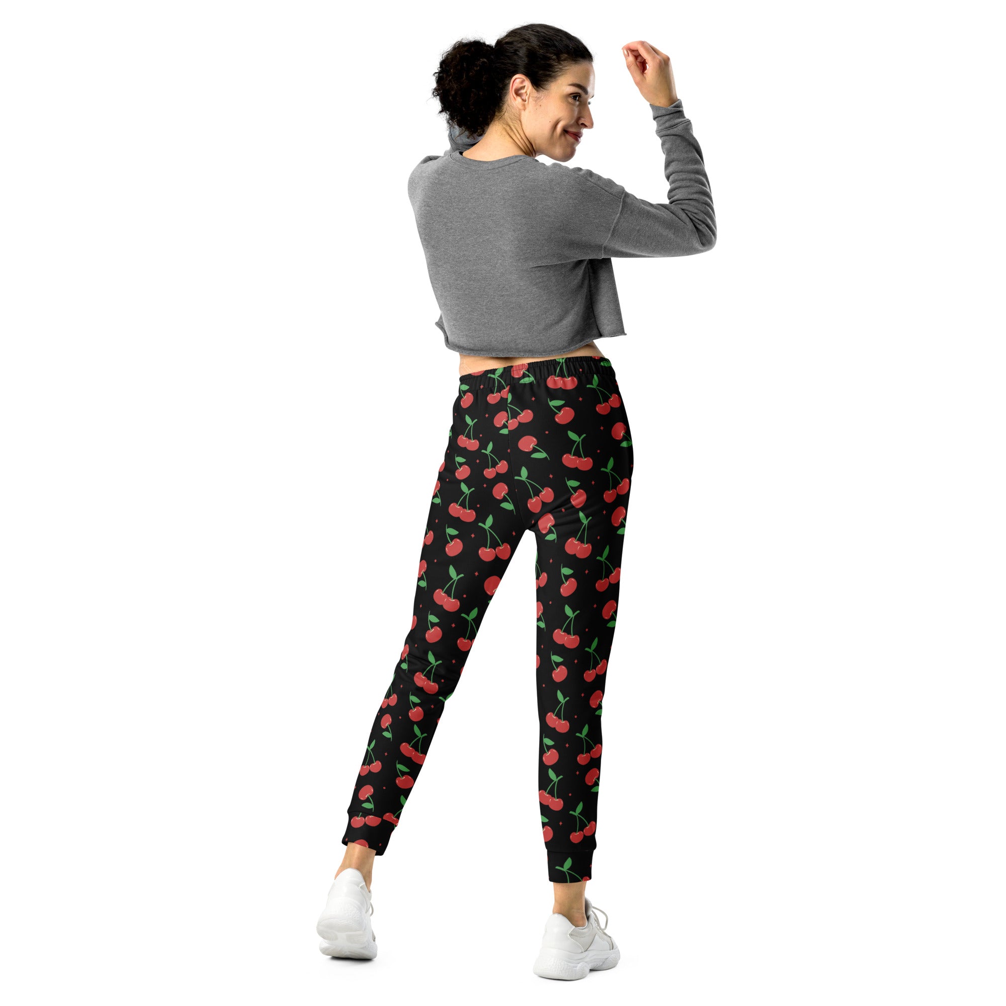 Women’s black cherry recycled jogger pants with vibrant red cherry pattern and cozy brushed inside fleece lining