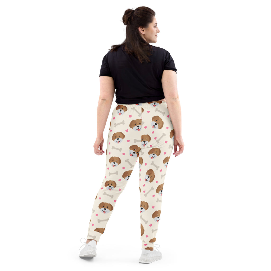 Cream-colored women’s jogger pants with dog and bone print, cozy brushed fleece inside and pockets, made from recycled fabric