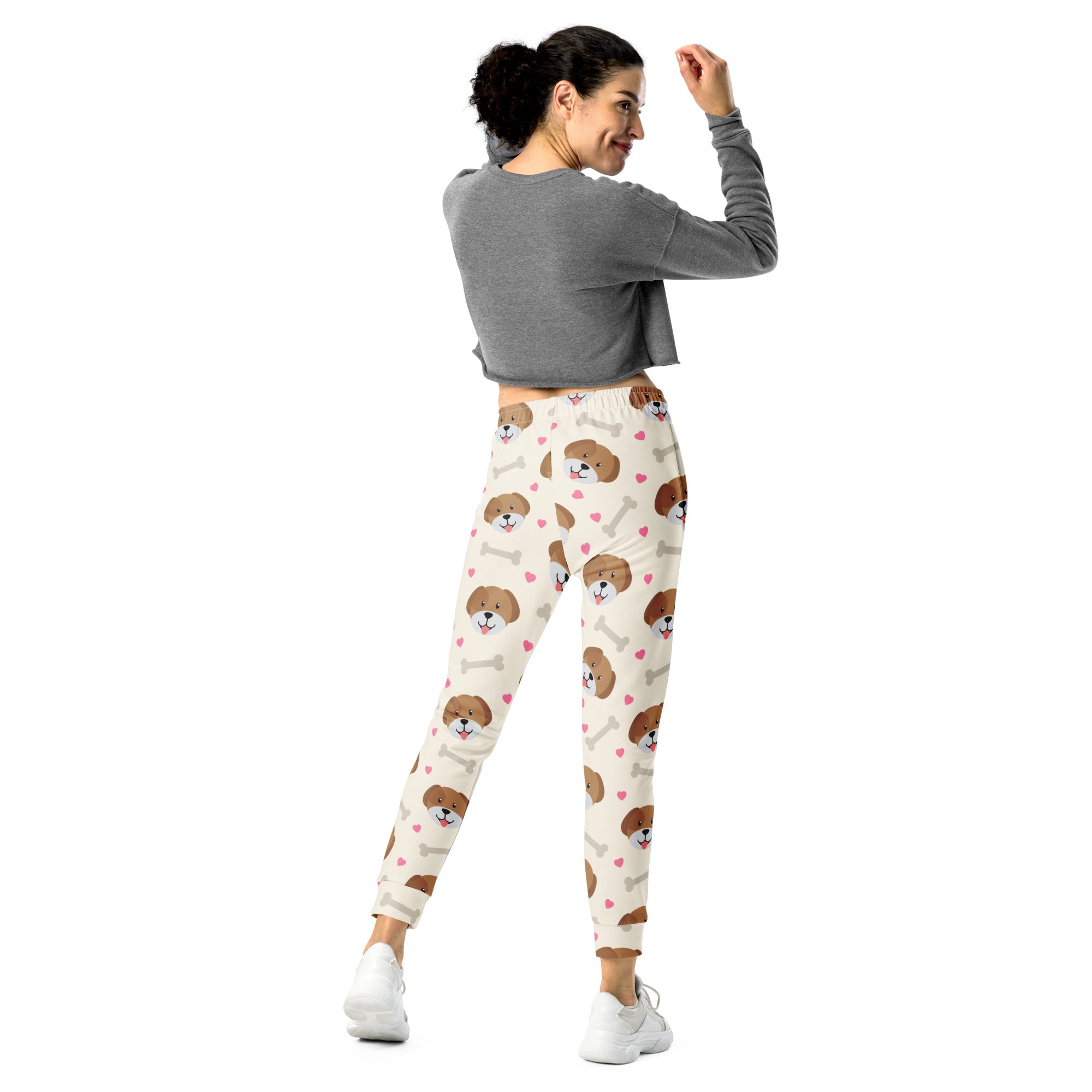 Cream-colored women’s jogger pants with brown puppy face and bone print made from cozy recycled fleece with pockets