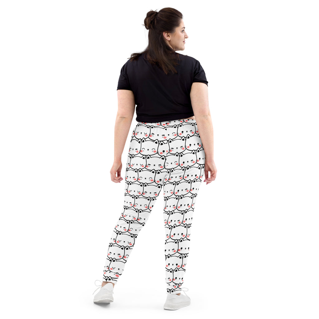 White leggings with a repeating cartoon white cat pattern featuring pink blush on cheeks made from cozy recycled fleece