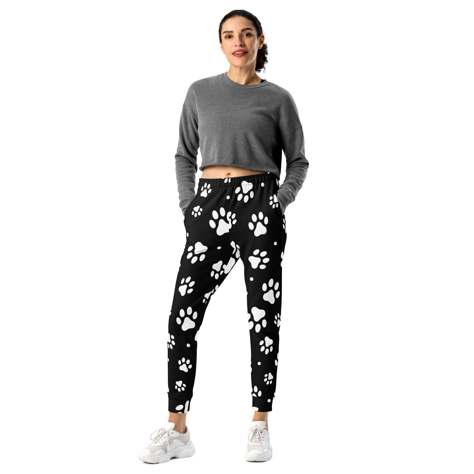 Women’s black jogger pants with white paw print pattern cozy brushed inside fleece and pockets made from recycled fabric