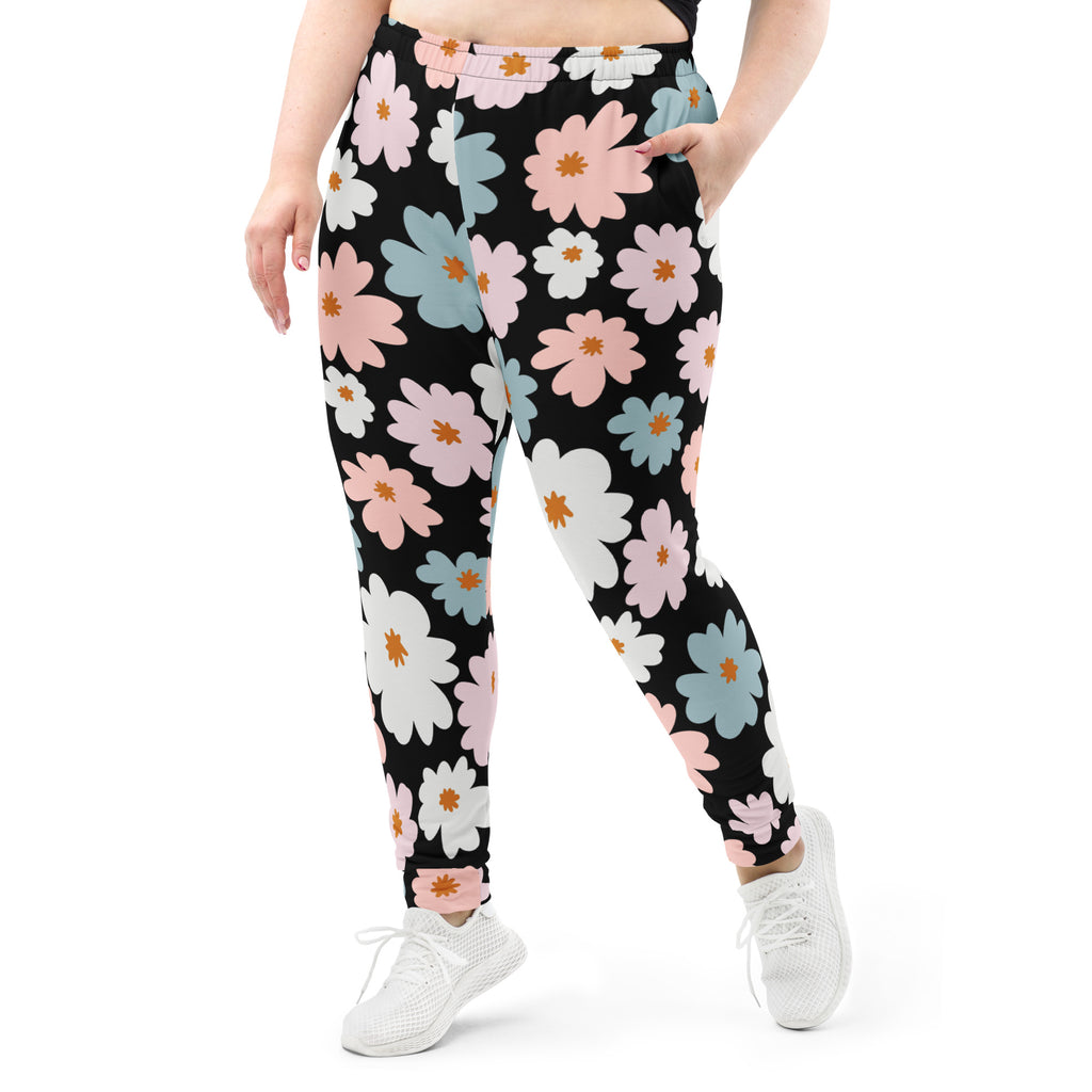 Women’s retro floral recycled jogger pants in black with pink white and blue flower pattern and cozy fleece lining