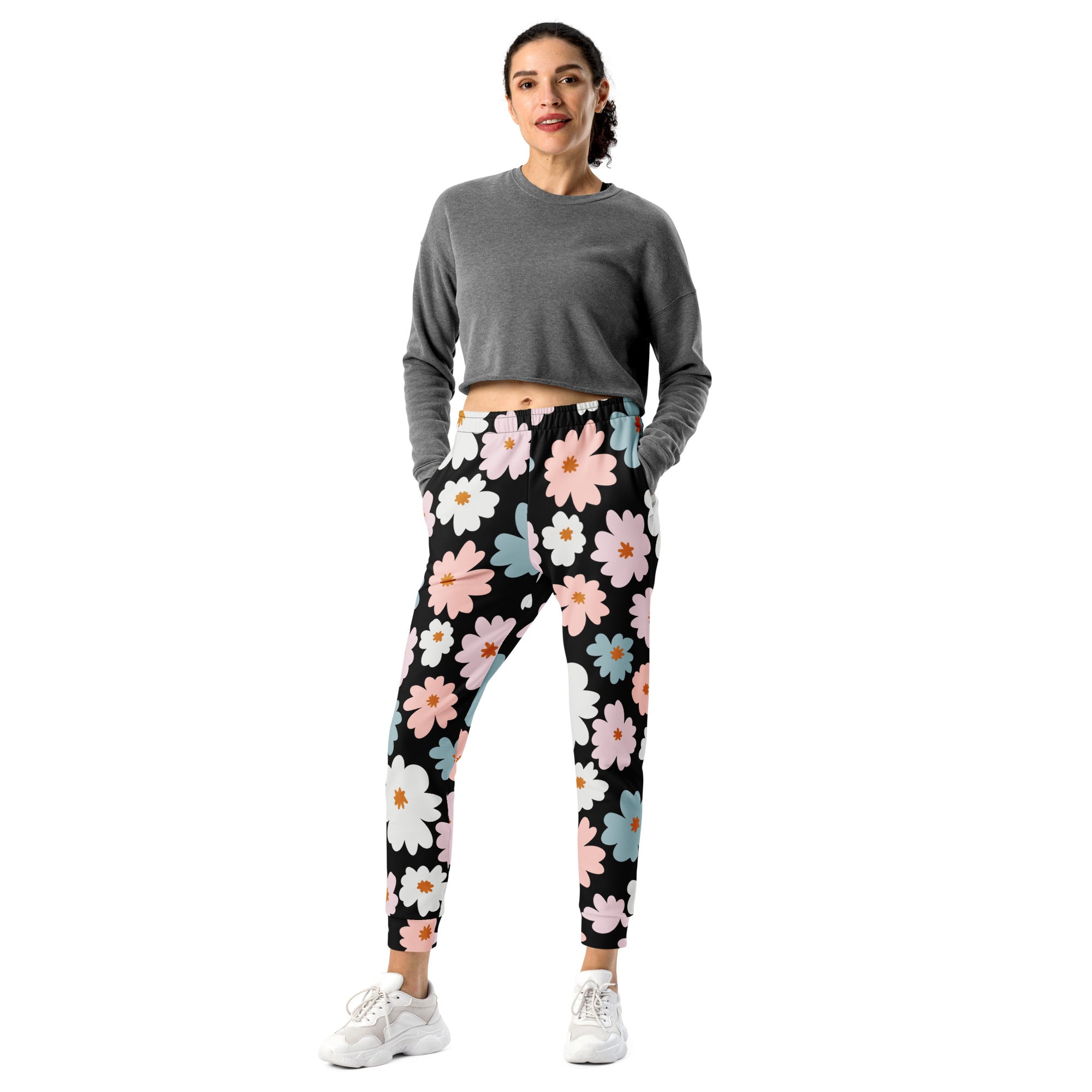 Women’s black jogger pants with vibrant pink white and blue daisy floral pattern cozy brushed fleece lining