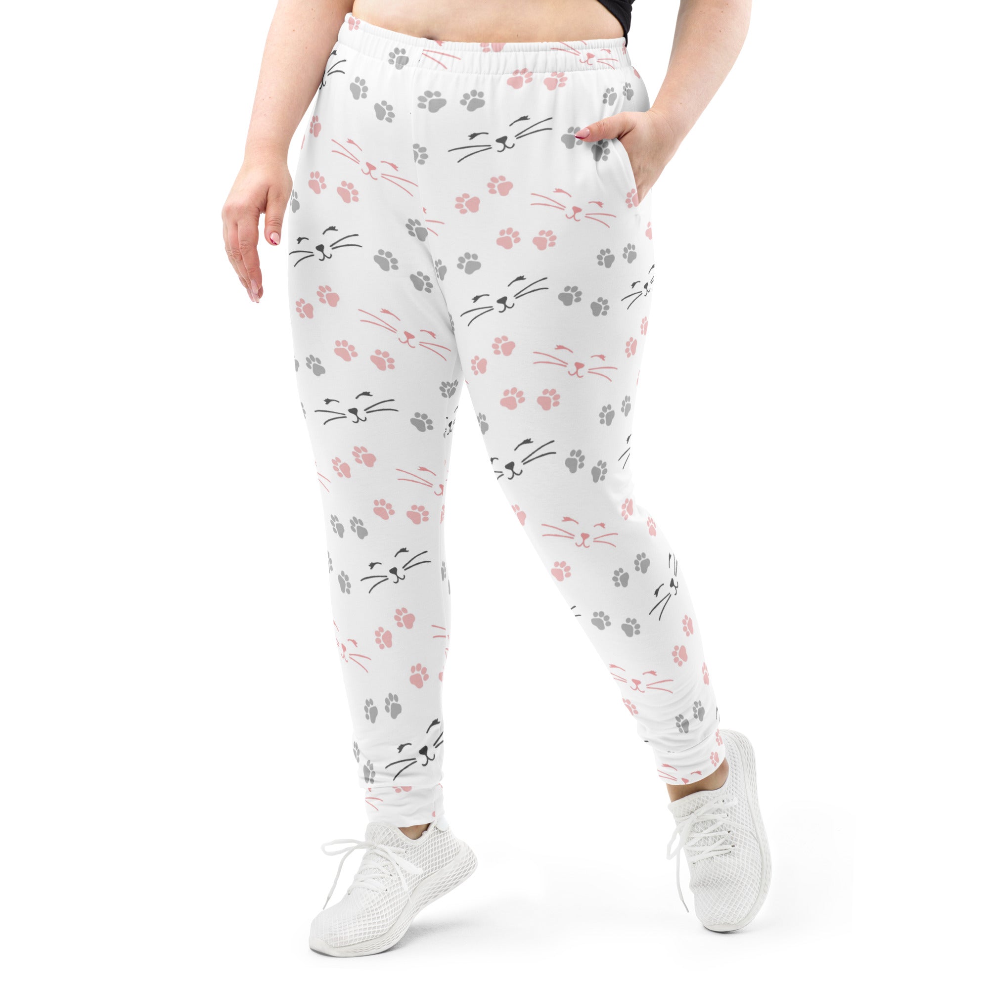 White plus-size joggers with pink and gray cat faces and paw prints made of cozy recycled brushed fleece with pockets