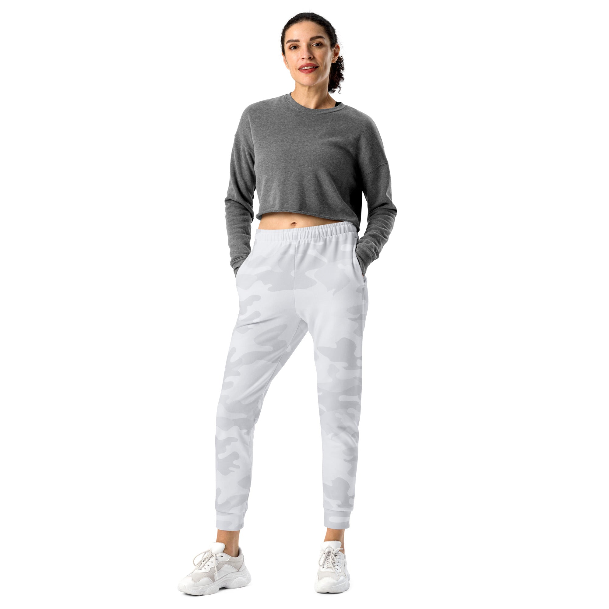 Women wearing gray camouflage recycled jogger pants with pockets and cozy brushed inside fleece paired with white sneakers