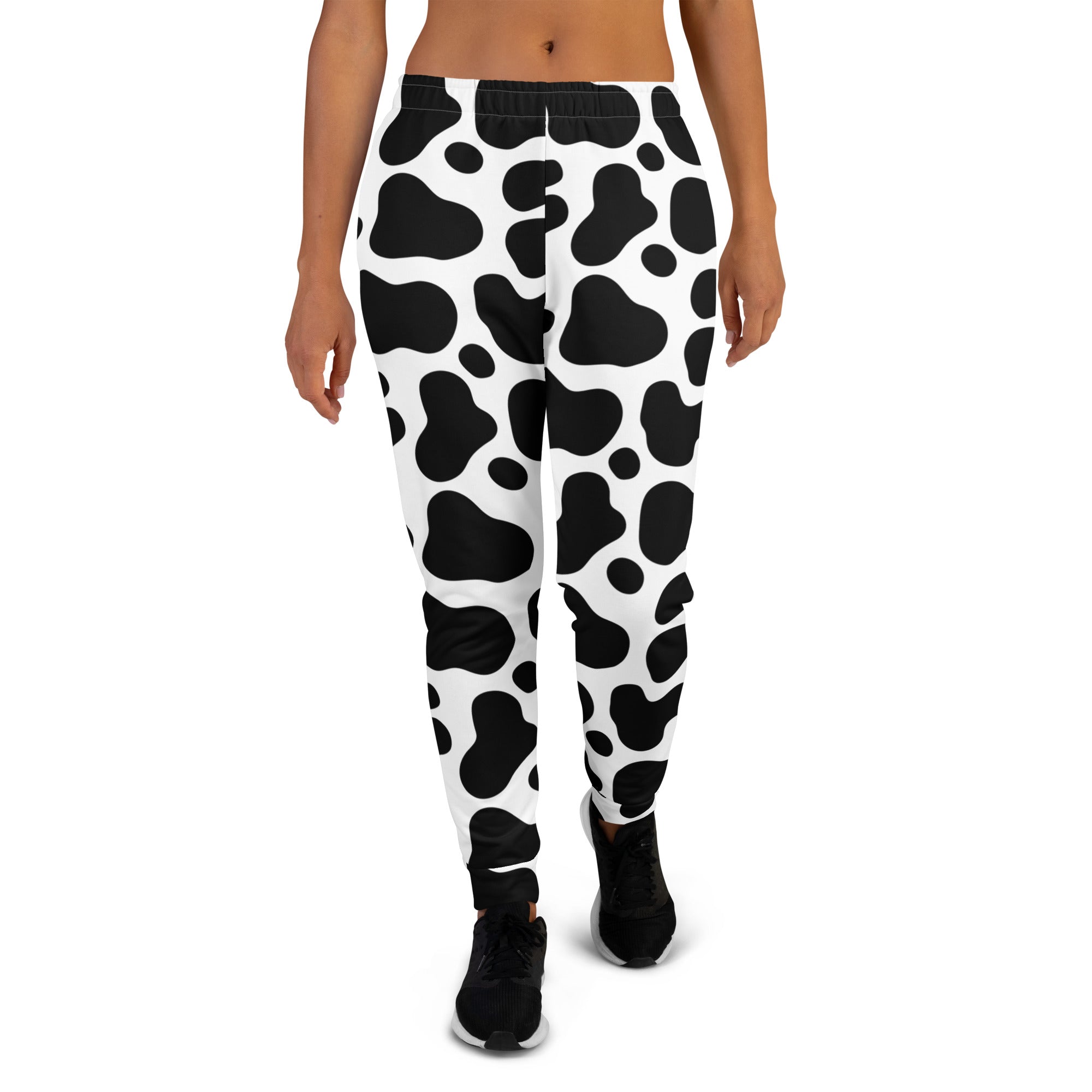 Women’s black and white cow print recycled jogger pants with pockets and cozy brushed inside fleece lining