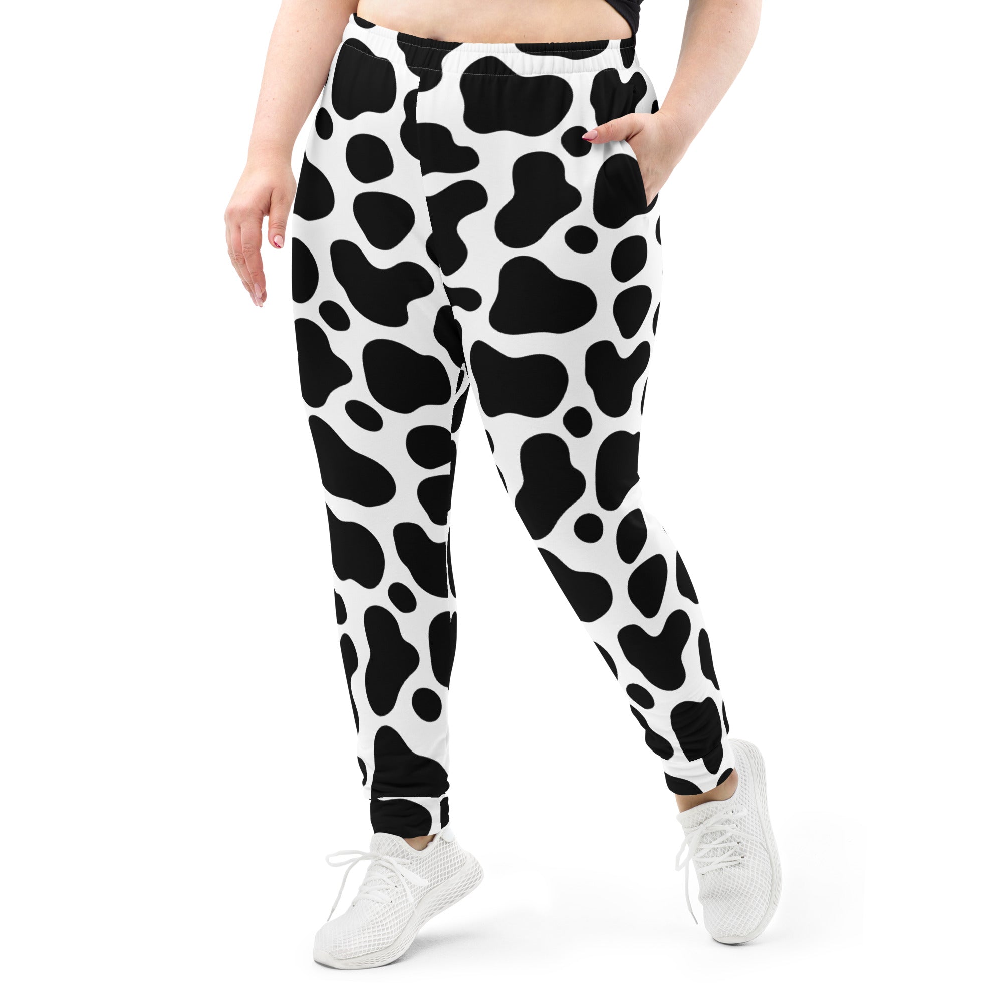Women’s black and white cow print recycled jogger pants with pockets and cozy brushed inside fleece lining