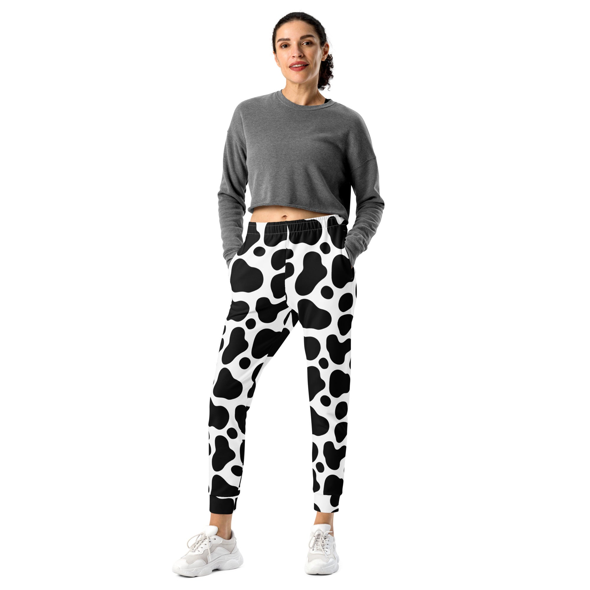 Women’s black and white cow print recycled jogger pants with pockets and cozy brushed inside fleece lining