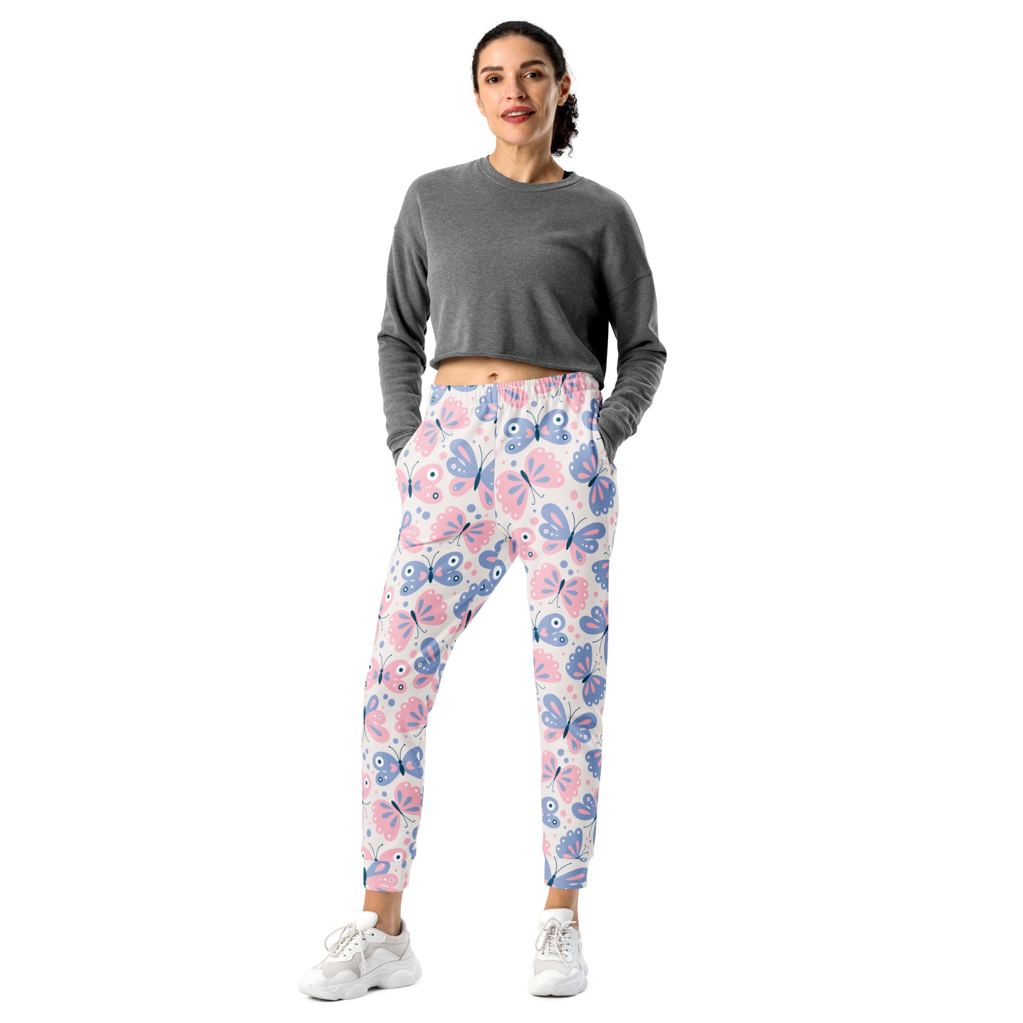 Women’s butterfly recycled jogger pants with pink and blue pattern on white base and cozy brushed fleece lining
