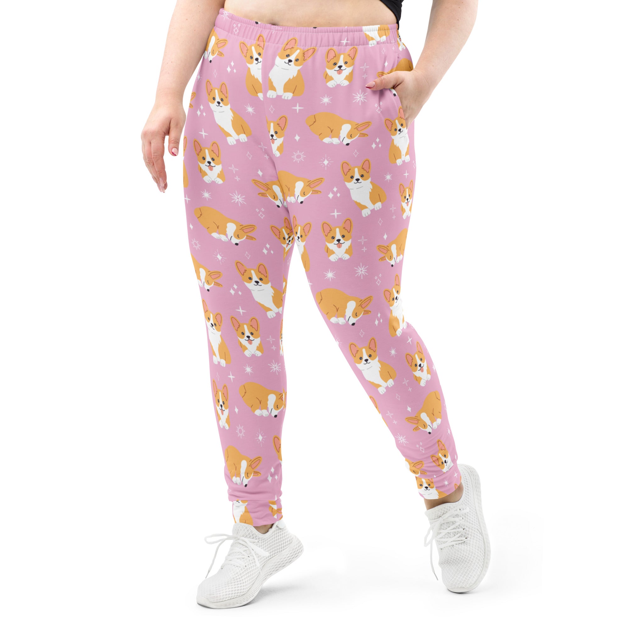 Women’s pink plus-size jogger pants with playful orange and white corgi pattern cozy recycled fleece with pockets