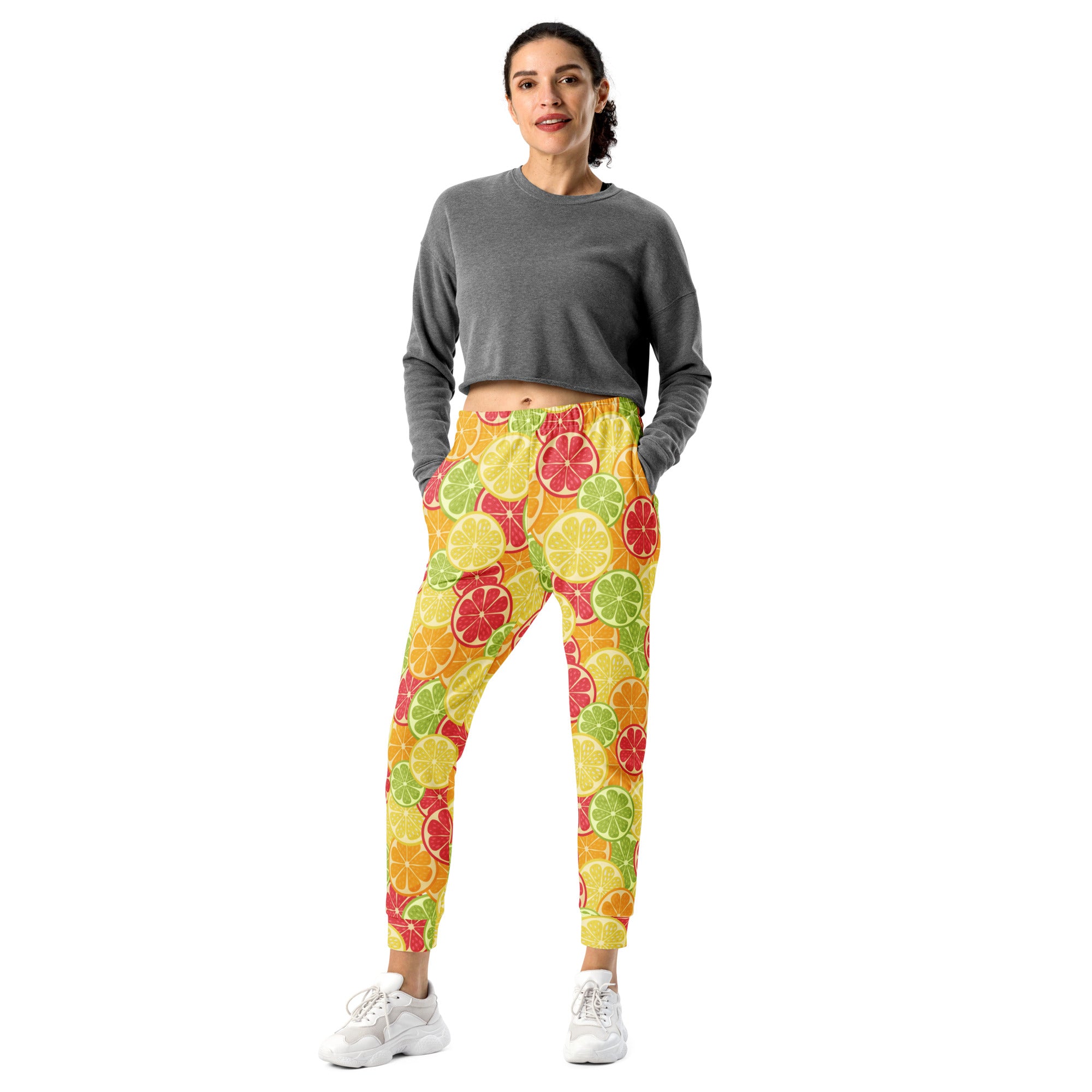Bright yellow women’s recycled jogger pants with vibrant sliced citrus pattern and cozy brushed fleece inside pockets