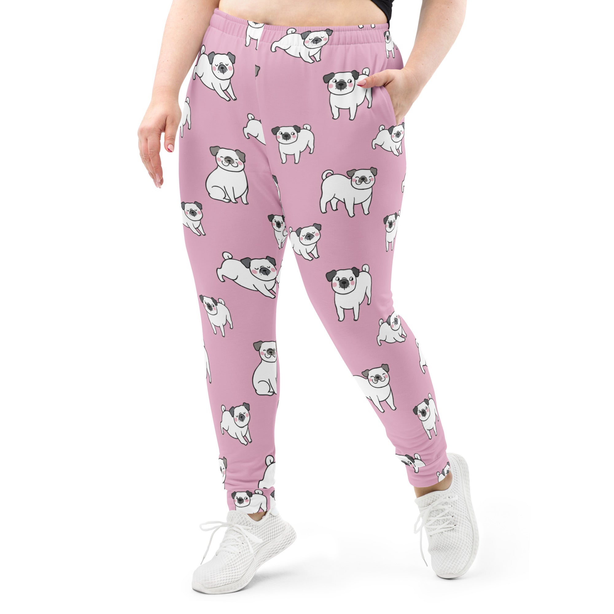 Women’s pink jogger pants with pockets featuring playful cartoon pugs all-over print and cozy brushed fleece lining