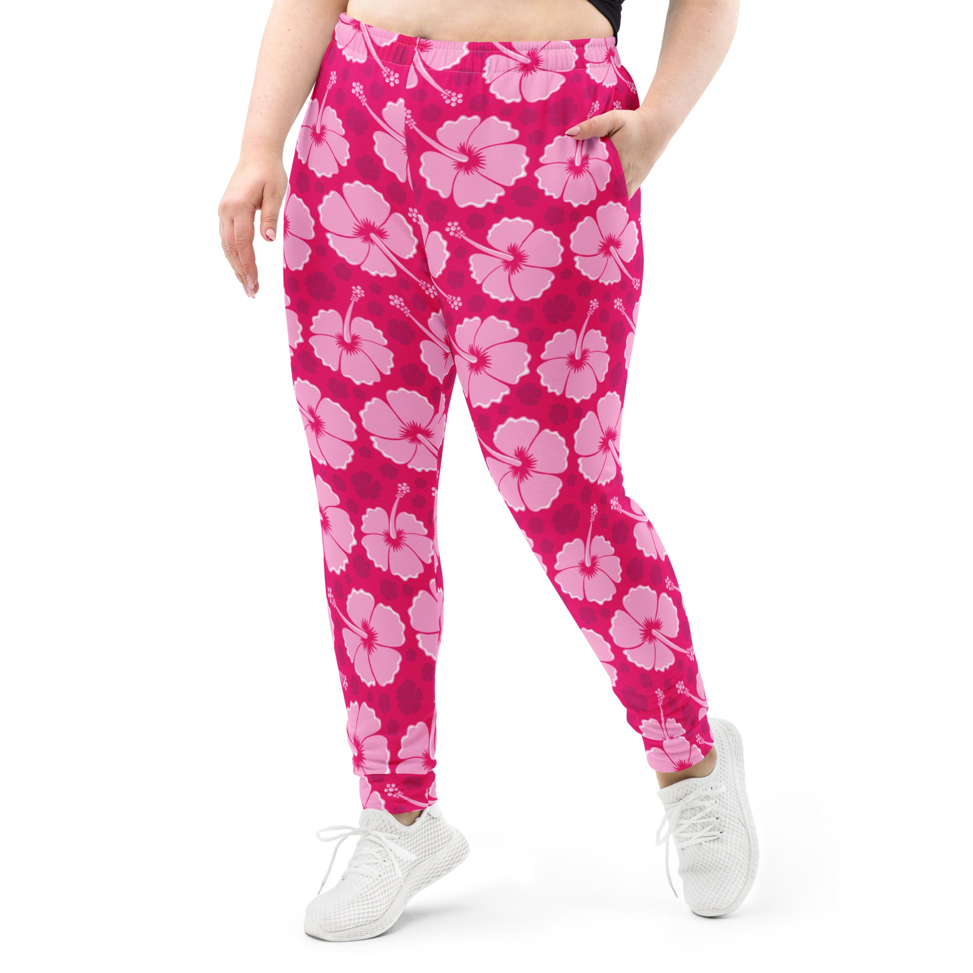 Plus-size pink hibiscus floral jogger pants with cozy brushed inside fleece and pockets made from recycled material