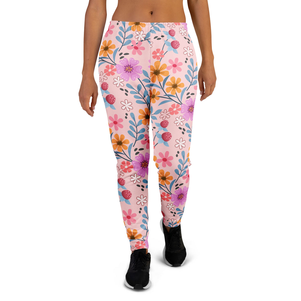 Women’s pink floral recycled jogger pants with pockets featuring vibrant purple orange and white flowers and cozy fleece