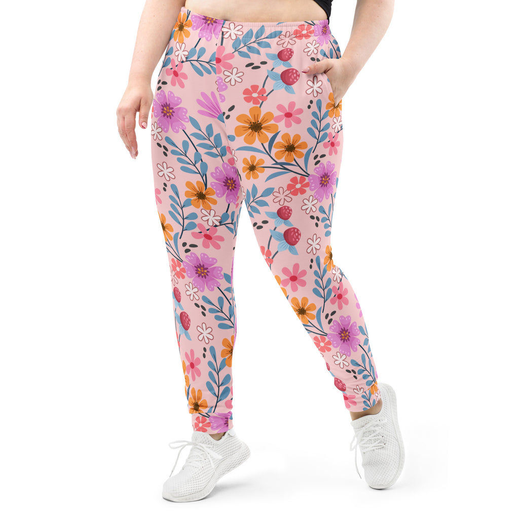Women’s pink floral recycled jogger pants with vibrant flowers and strawberries on soft brushed fleece fabric with pockets