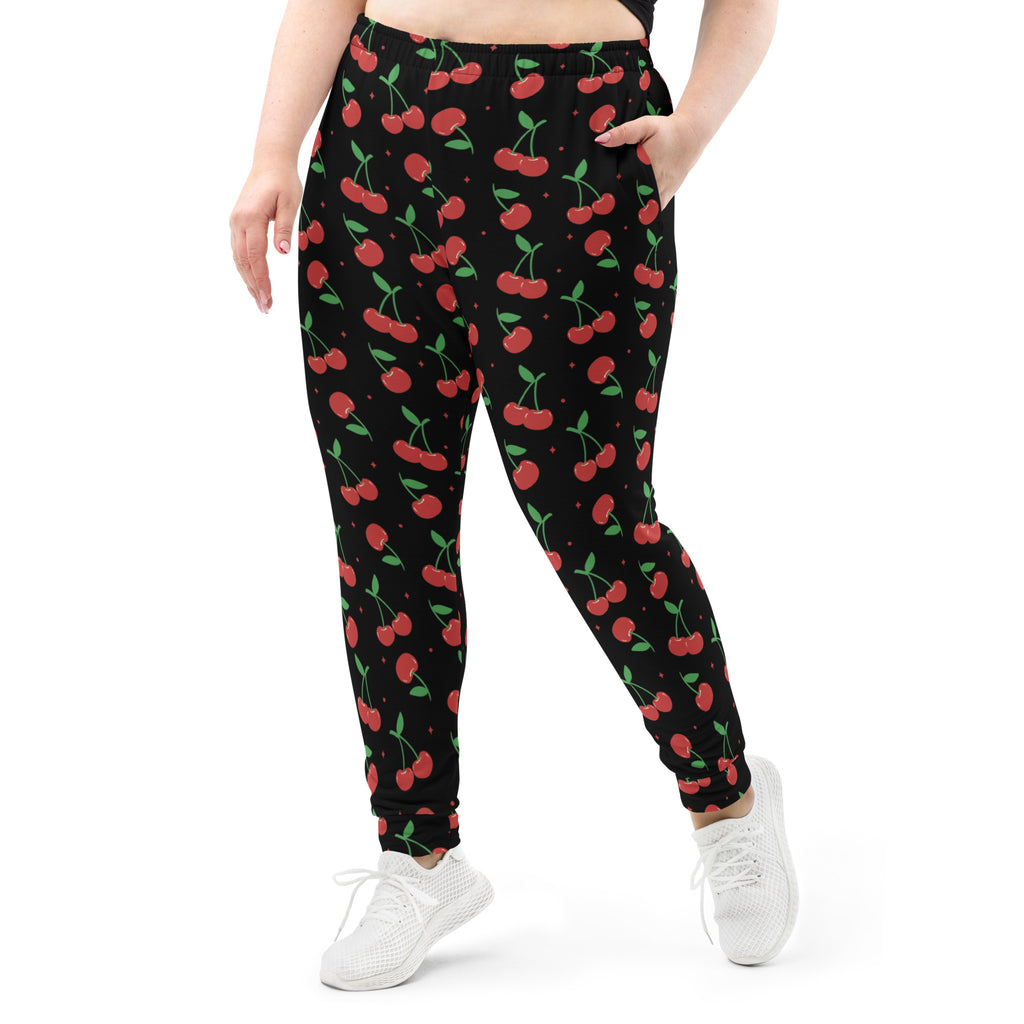 Women’s black cherry recycled jogger pants with red cherry print and cozy brushed inside fleece lining