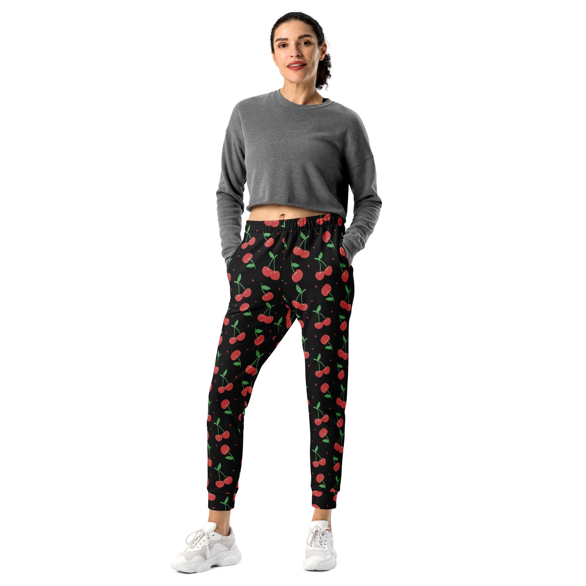 Women’s black cherry recycled jogger pants with pockets feature vibrant red cherry print and cozy brushed fleece inside