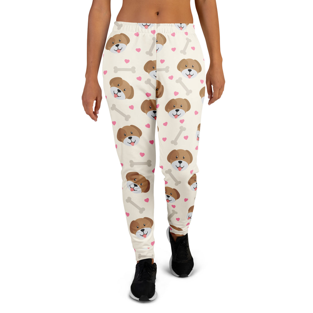 Cream-colored women’s recycled jogger pants with brown puppy faces pink hearts gray bones cozy brushed fleece lining