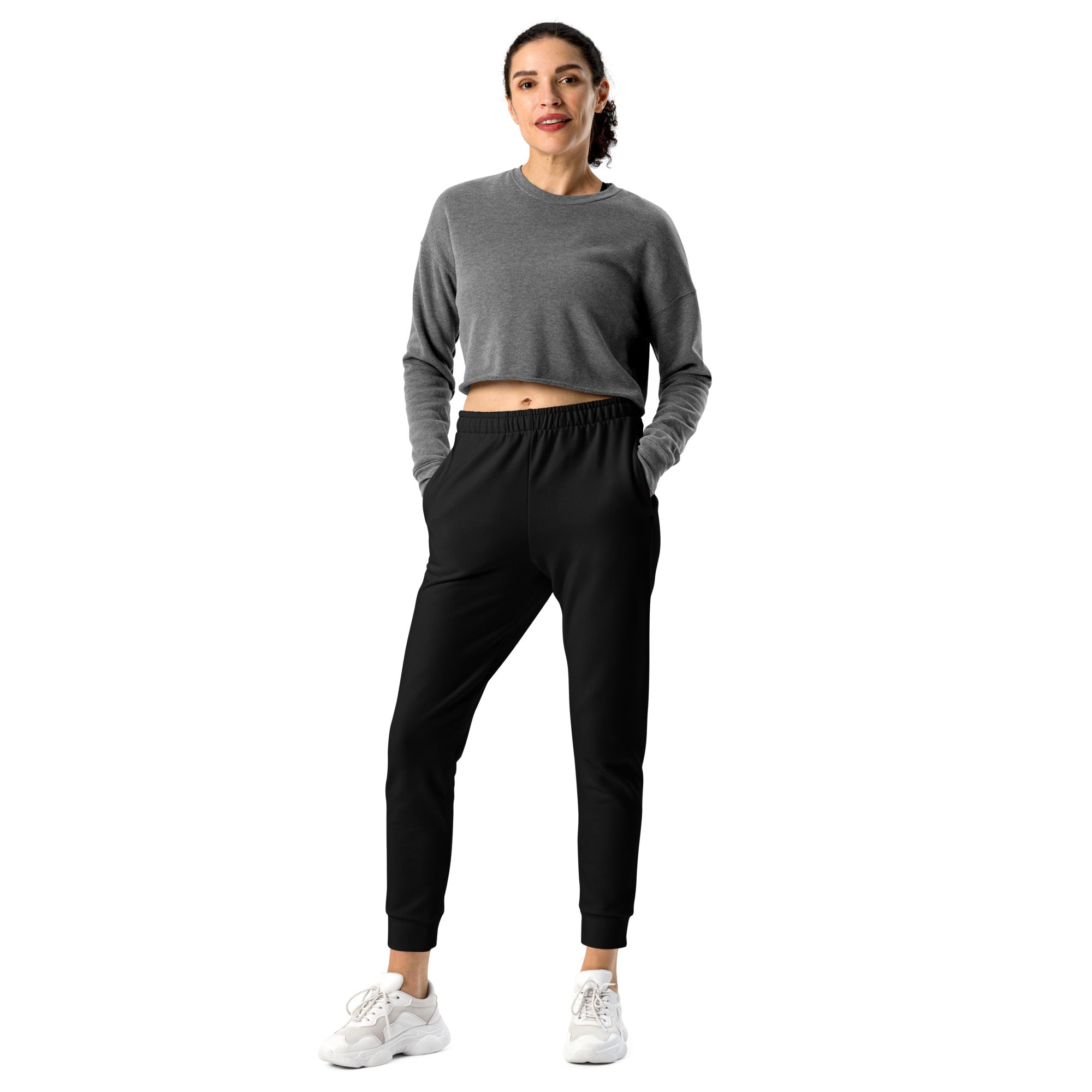 Gray cropped long sleeve sweatshirt with elastic waistband and relaxed fit paired with black recycled jogger pants with pockets