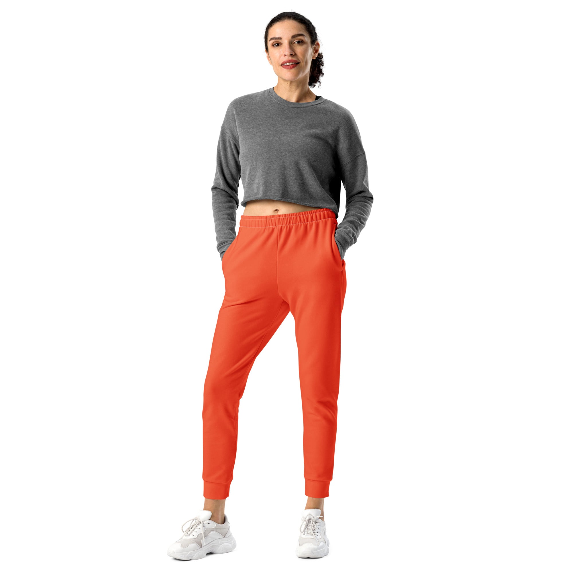Women’s orange recycled jogger pants with elastic waistband ribbed cuffs pockets and cozy brushed inside fleece lining