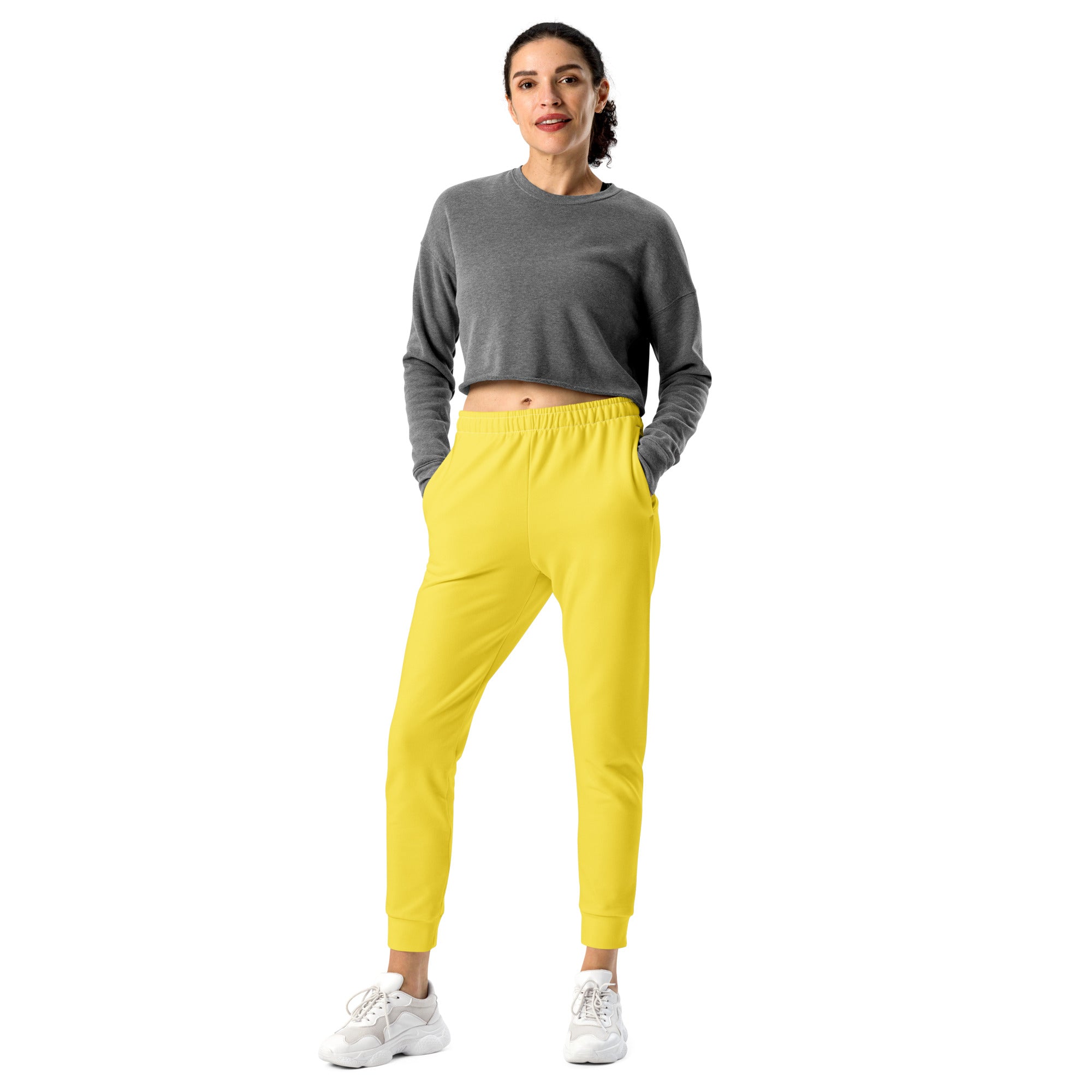 Bright yellow women’s jogger pants with elastic waistband tapered legs made from recycled cozy brushed fleece