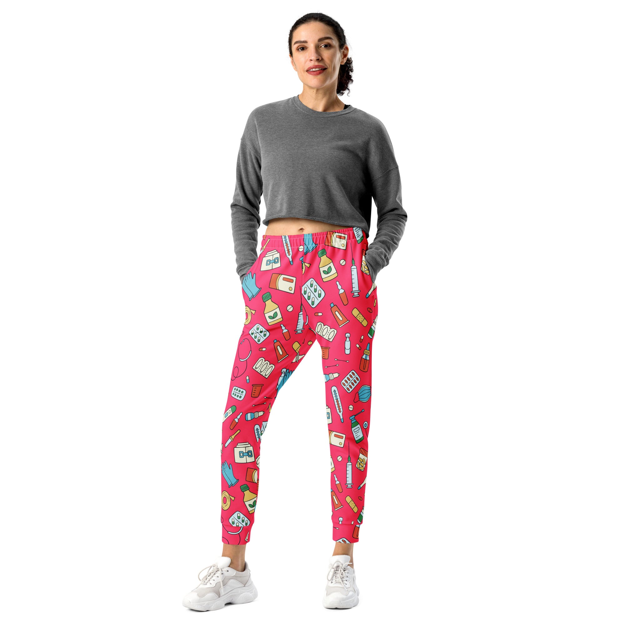 Women’s bright pink recycled jogger pants with playful medical supply print and cozy brushed inside fleece pockets