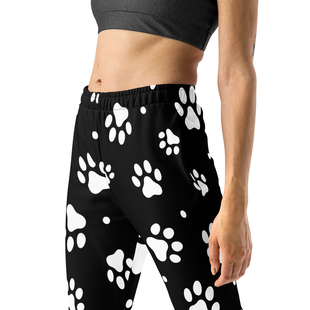Women’s black recycled jogger pants with cozy brushed fleece inside featuring playful white paw print pattern and pockets